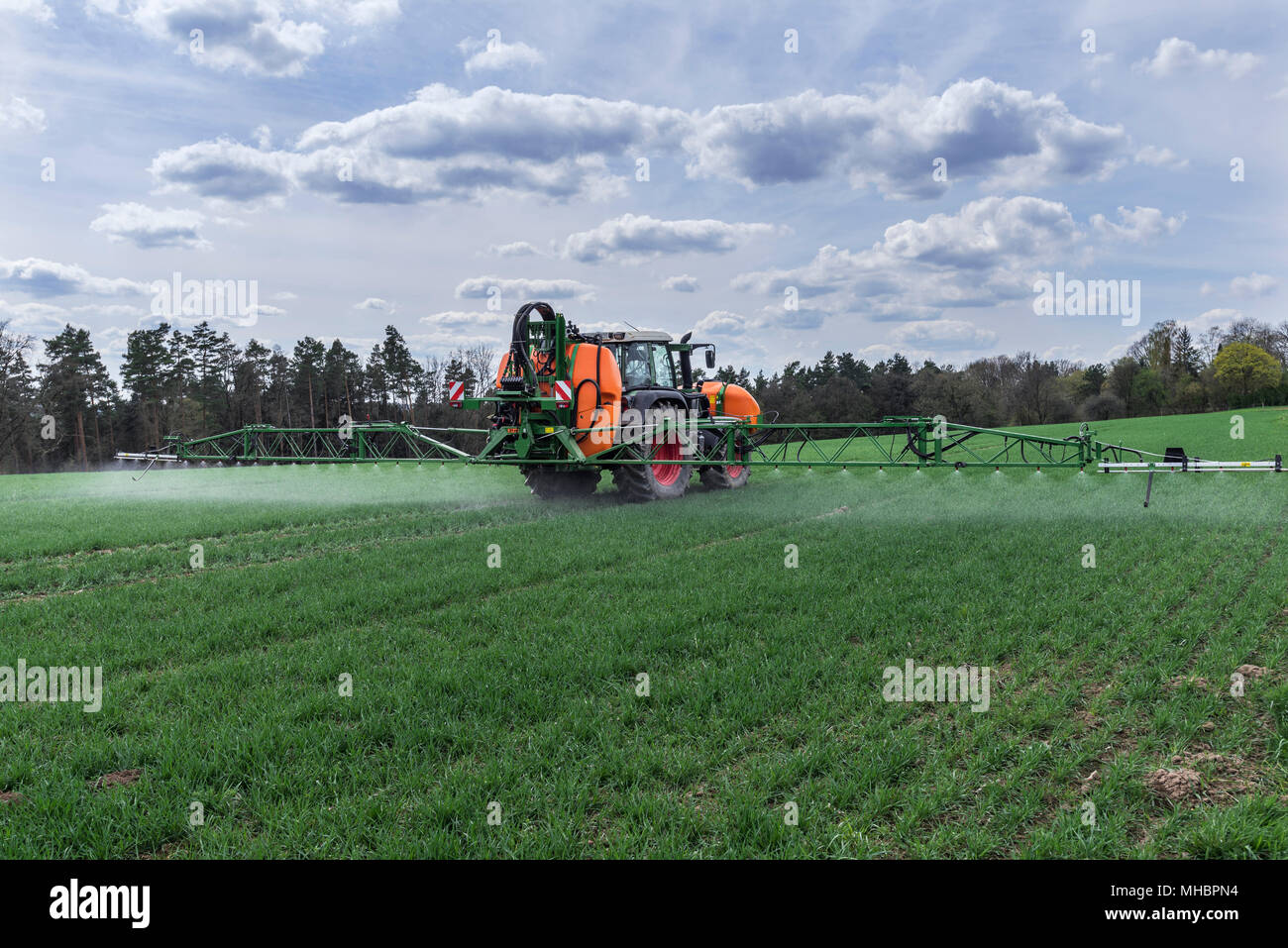 Moderne High-Tech-Spritze im Einsatz auf einem Keimenden Weizenfeld, Franken, Bayern, Deutschland Stockfoto