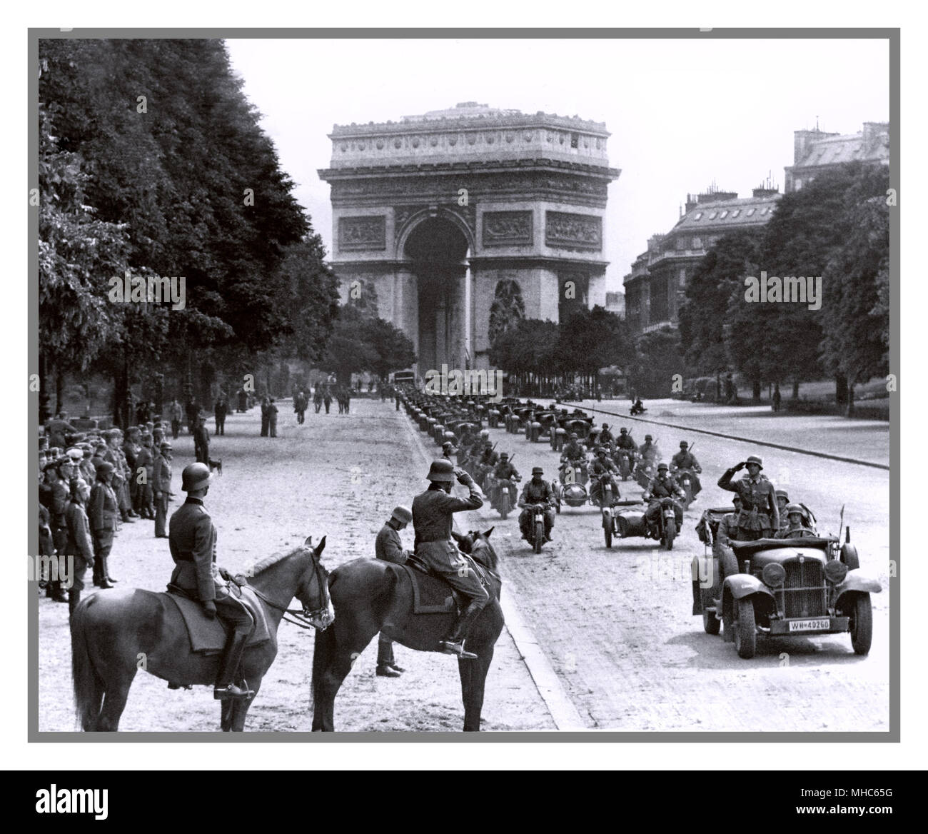 PARIS FRANKREICH NAZI-BESETZUNG II. Weltkrieg 1940 Nazi-deutsche Besatzungstruppen treten in Paris ein Deutsche Soldaten marschieren hinter Paris Frankreich auf der Avenue Foch mit dem Triumphbogen 14. Juni 1940 Stockfoto