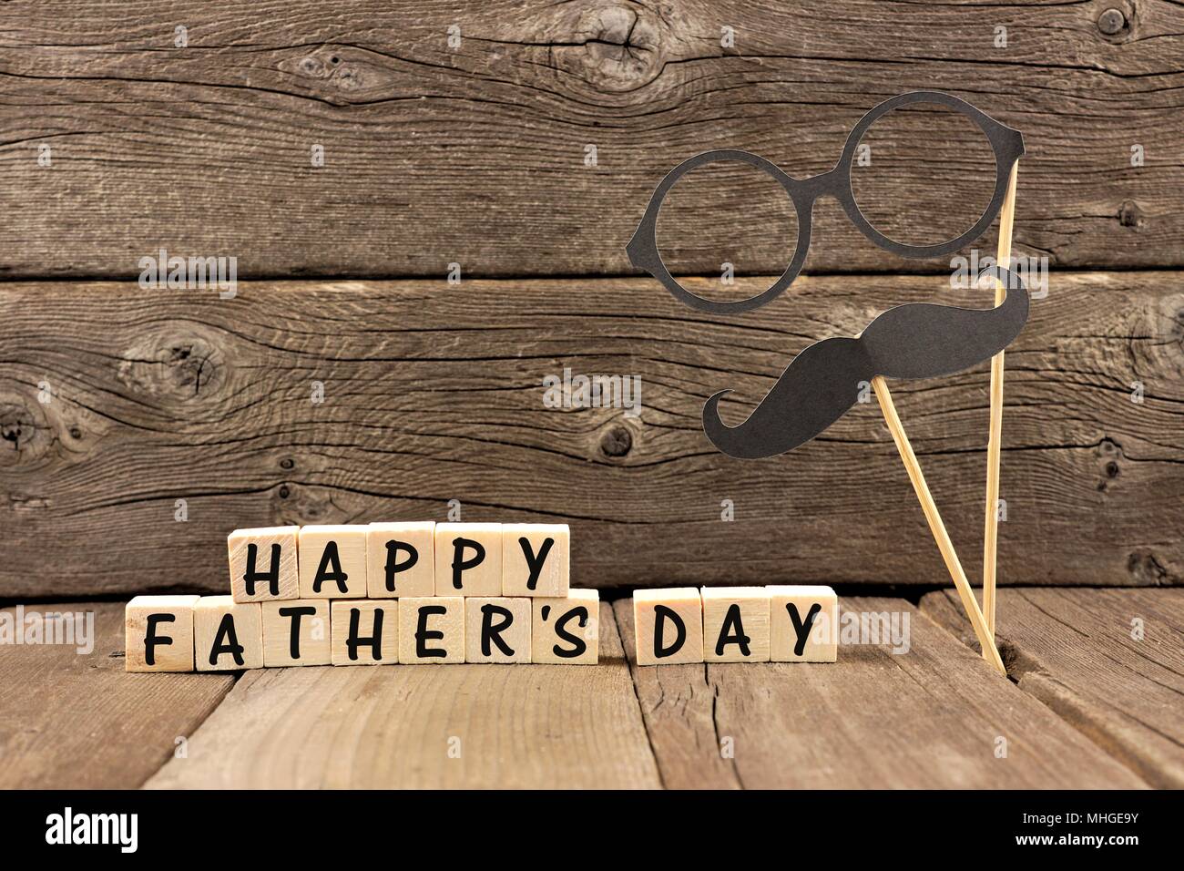 Happy Vatertag Holzblöcke mit Schnurrbart und Gläser gegen einen rustikalen Holzmöbeln Hintergrund Stockfoto