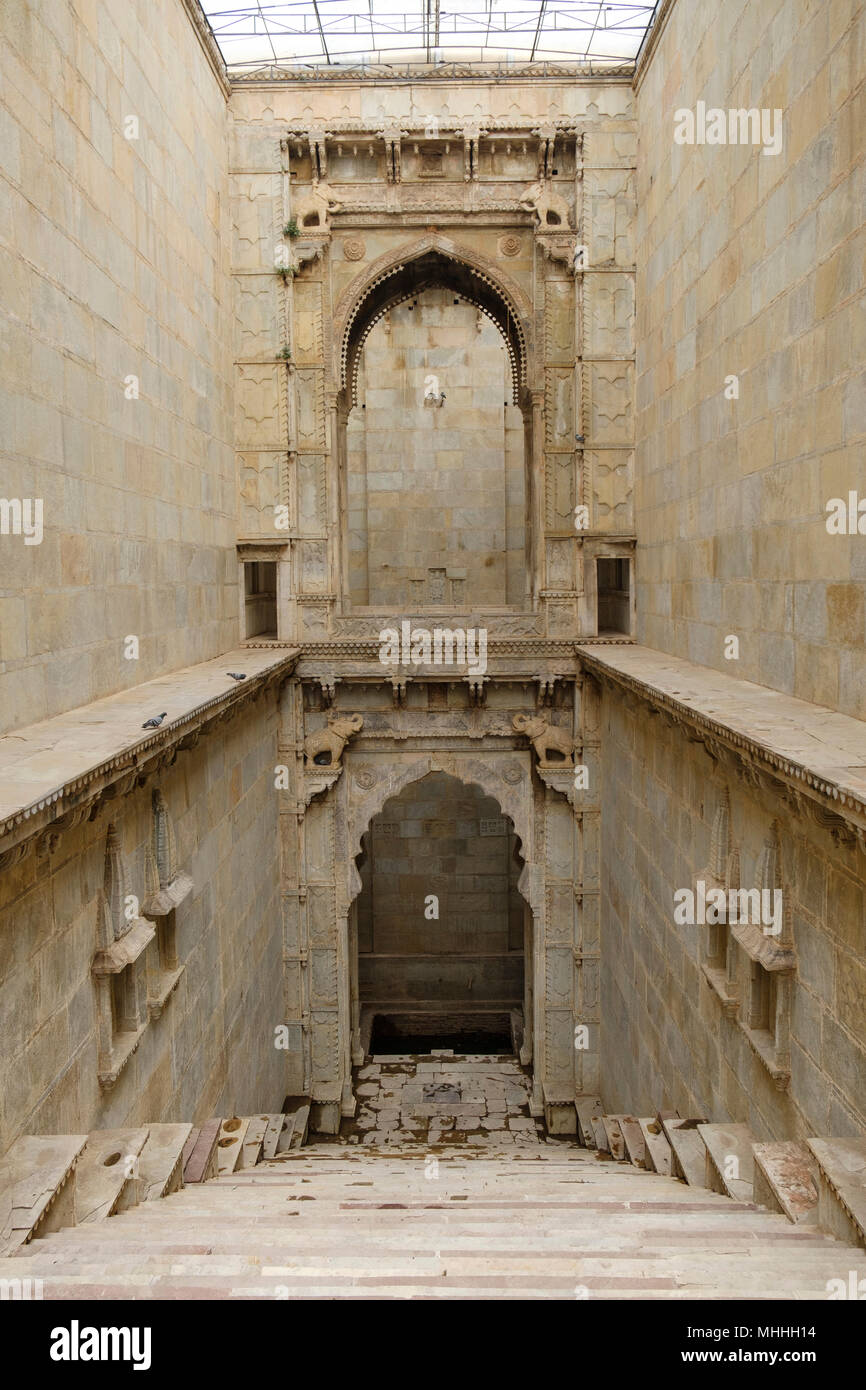 Raniji Ki Baori Stepwell, Bundi. Rajasthan, Indien. Diese baori wurde 1699 von Rani Nathavati Ji, die junge Königin der herrschenden Maharao Raja Anirudh Singh von Bundi gebaut. 46 Meter tief, das Gut abgestufte ist ein Multi-stöckige Struktur mit Brillant geschnitzten Säulen und eine hohe gewölbte Tor eingerichtet. Jede Etage verfügt über spezielle Orte der Anbetung für die Menschen die Ehre zu erweisen. Man Kann die baori durch einen schmalen Eingang von vier Säulen markiert ein. Lebensechte Elefant Statuen aus Stein Guard die Ecken. Stockfoto