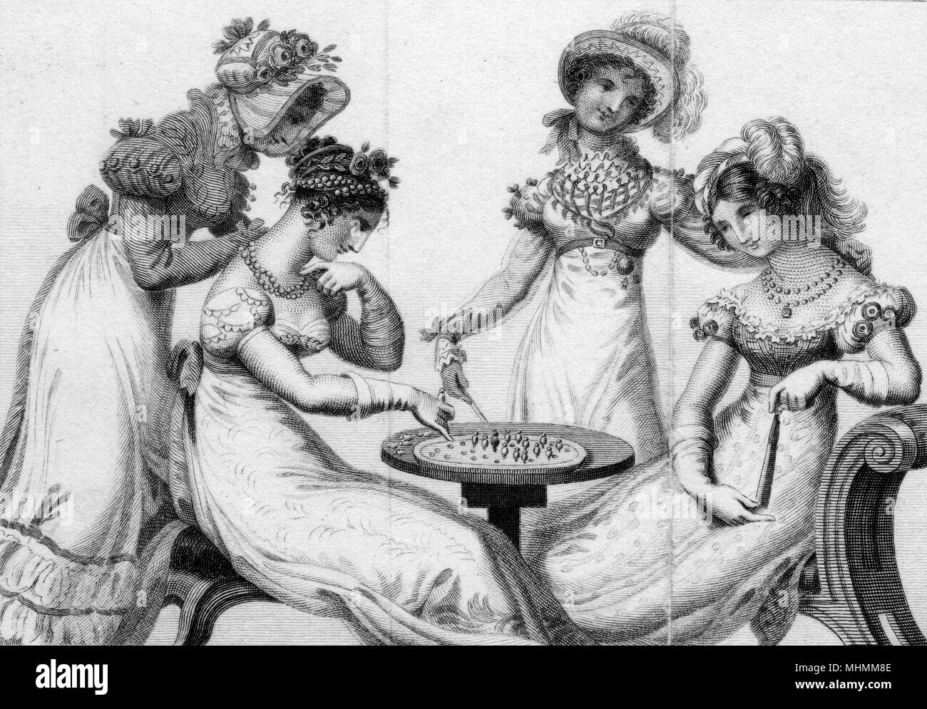 Vier modische Damen spielen Solitaire. Datum: Anfang des 19. Jahrhunderts Stockfoto