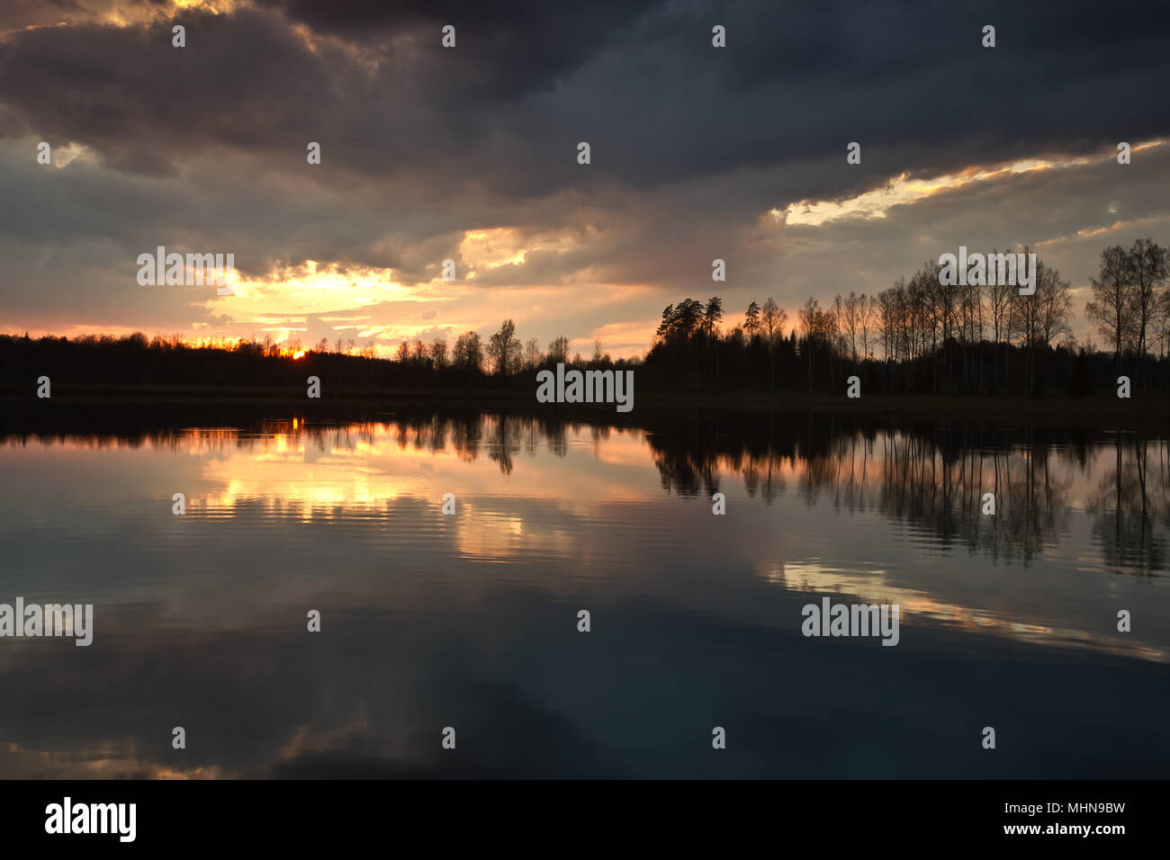 Symmetrische Sonnenuntergang Spiegelbild im See, Lettland Stockfoto