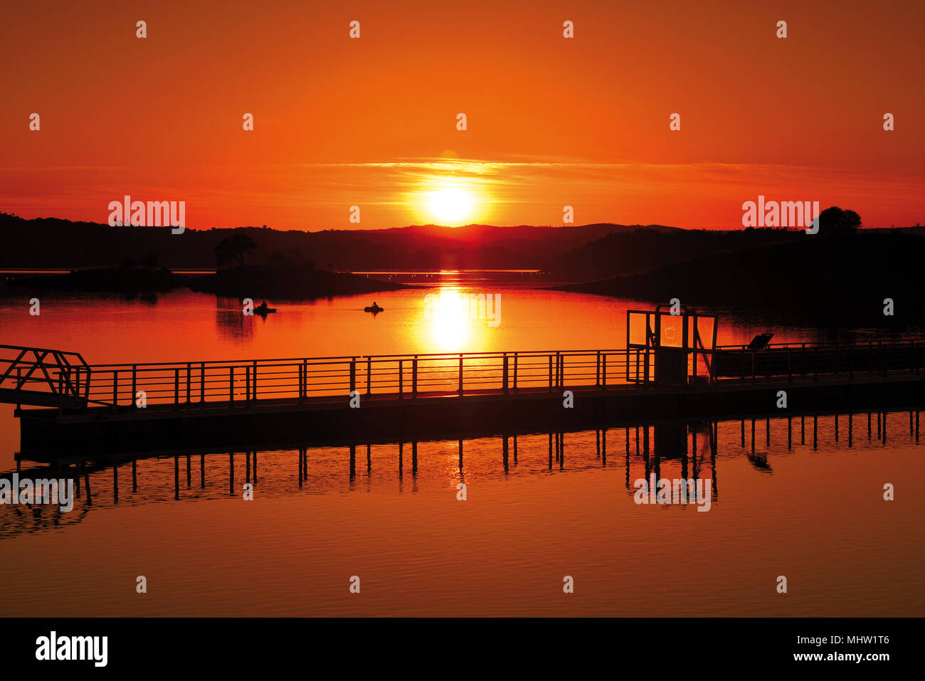 Einen malerischen Sonnenuntergang mit orange Horizont über See mit Boot starten Stockfoto