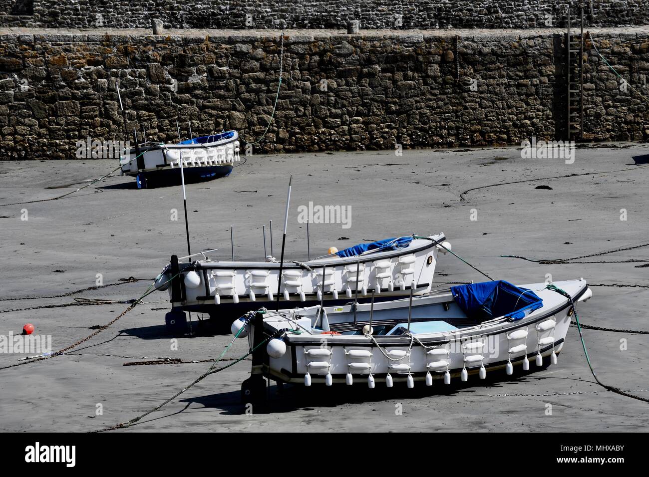 Drei Boote im St Michael Mounts Hafen bei Ebbe Stockfoto