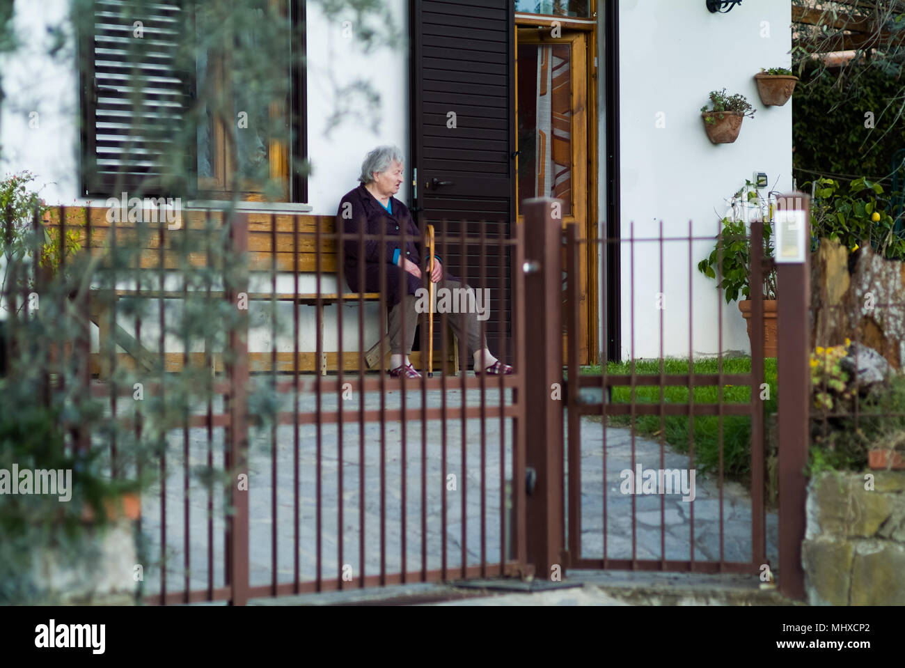 Alter Frau entspannende Sitzung neben ihrem Haus in der Landschaft um Florenz Toskana Italien Stockfoto