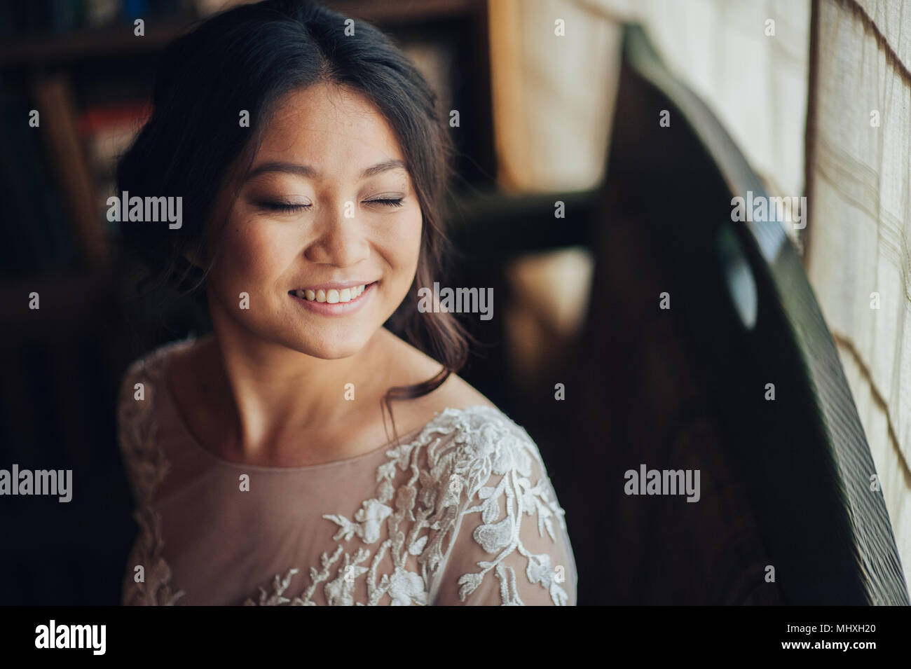 Lächelnd asiatische Braut in vintage Innenraum posing Stockfoto