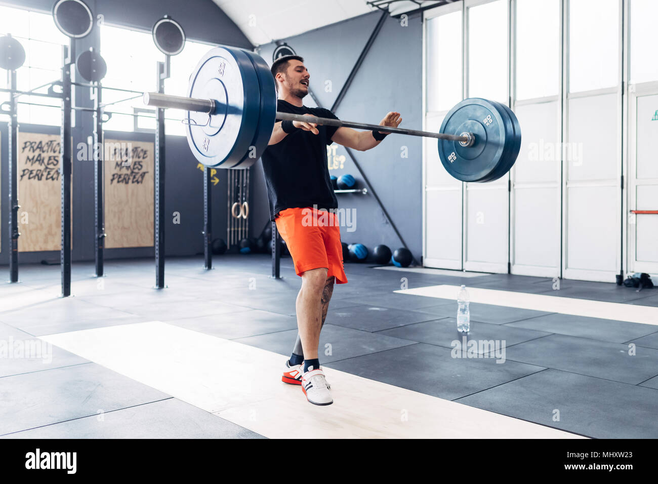 Mann weightlifting Barbell in der Turnhalle Stockfoto