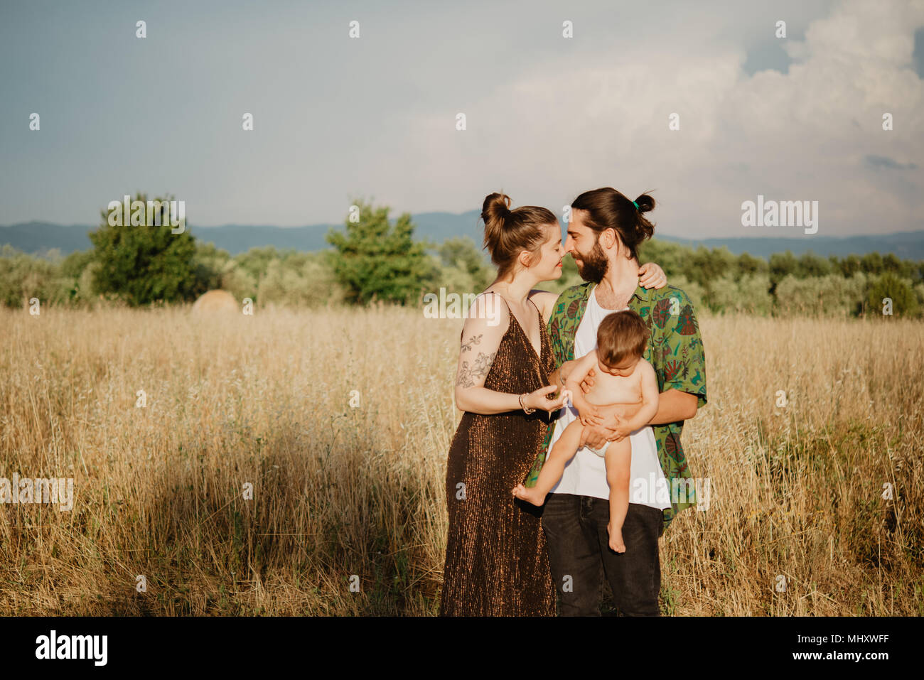 Paar mit Baby Mädchen auf goldenen Rasenfläche, Arezzo, Toskana, Italien Stockfoto