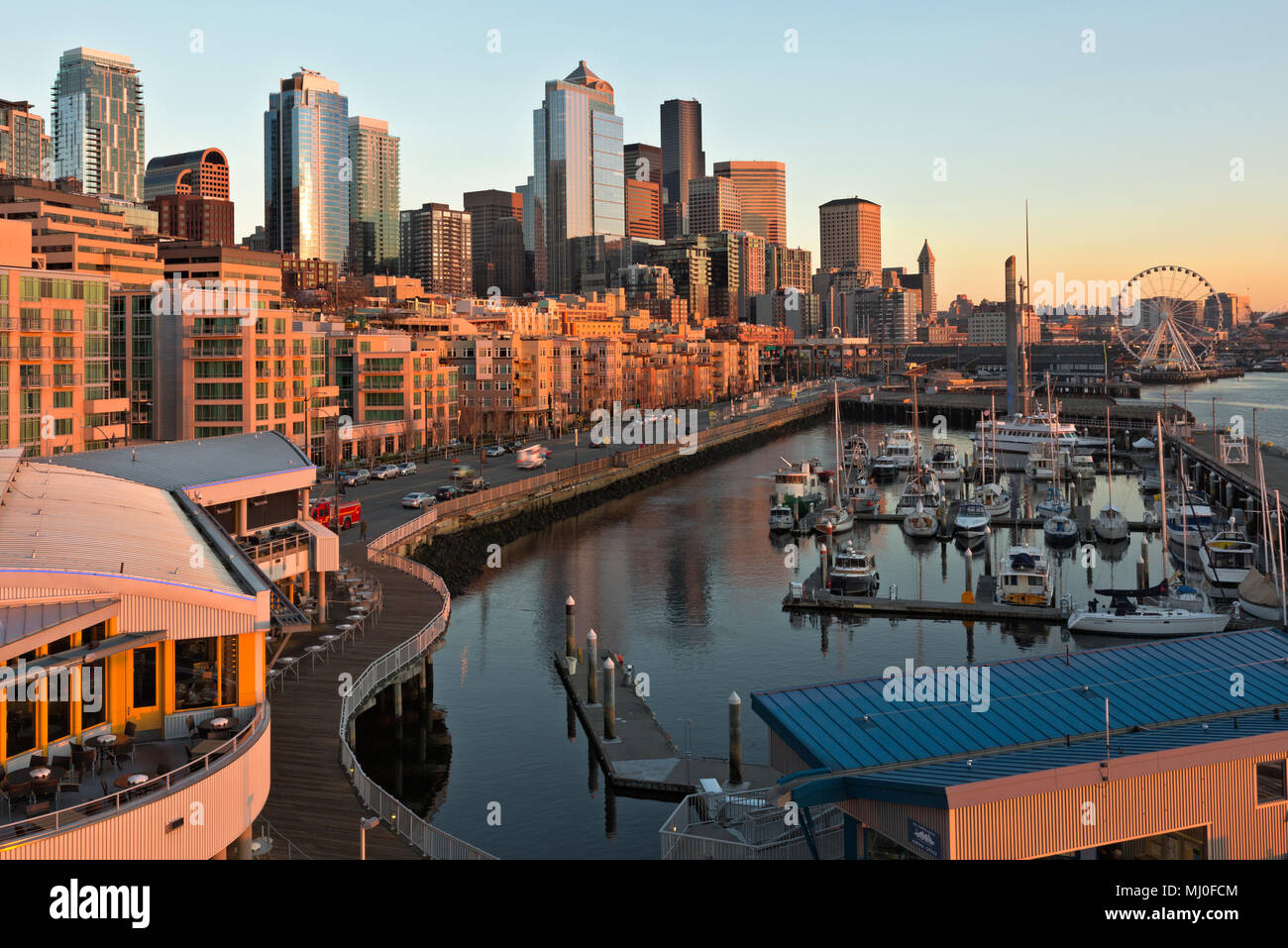 WA 15322-00 ... WASHINGTON - Sonnenuntergang über dem Seattle Waterfront von Pier 66, einschließlich der Bell Harbour Marina, das große Rad, Coleman Dock, hghrises, t Stockfoto