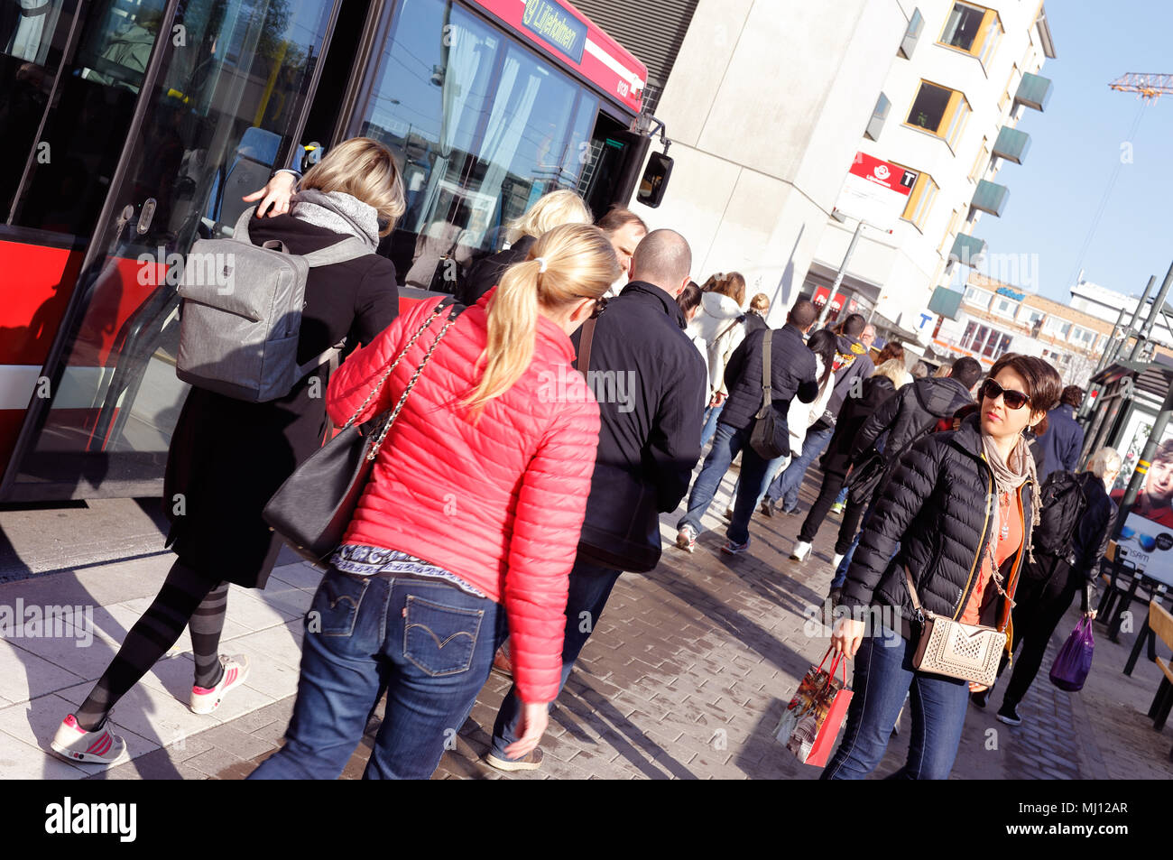 Stockholm, Schweden - 7. Mai 2015: Passagiere Ausgeschifft haben entgegenkommenden Bus zu Fuß in Richtung U-Bahn Station Liljeholmen bei rush hour. Stockfoto