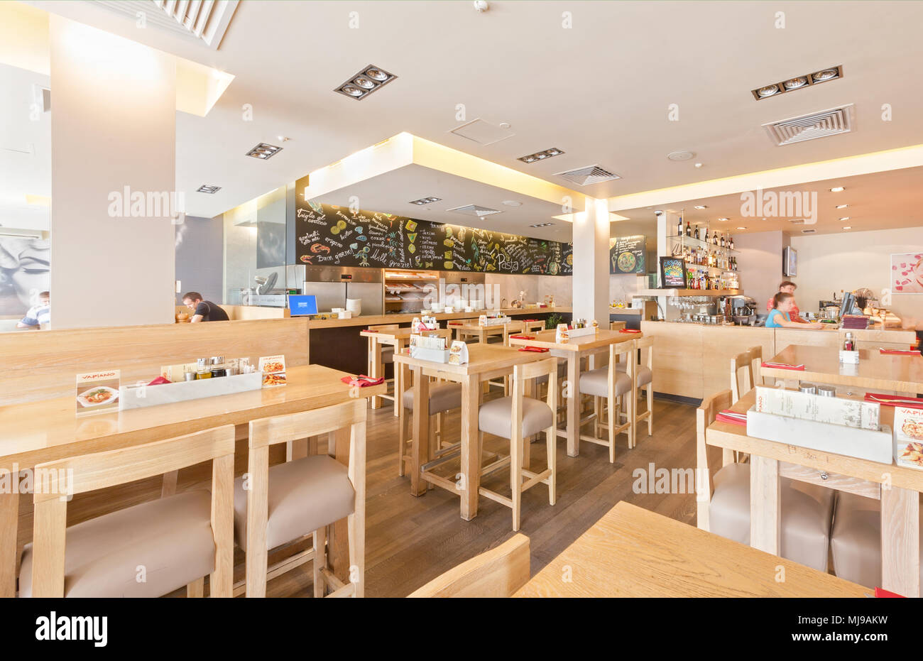 Moskau - AUGUST 2014: Einrichtung des internationalen Netzwerks der Italienischen hausgemachte Restaurants - "VAPIANO". Halle mit einer offenen Küche und Tabellen von OA Stockfoto