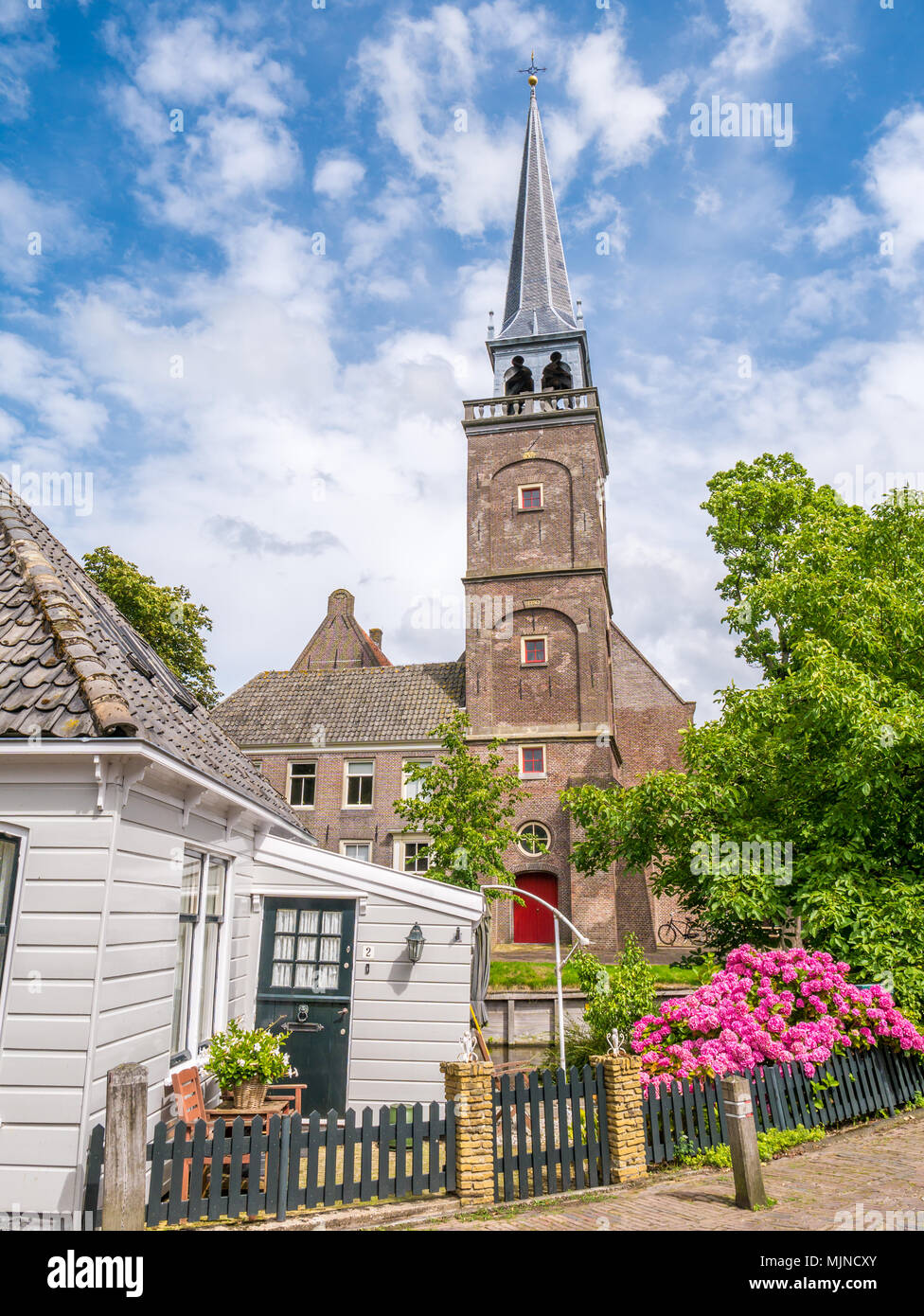 Street Scene mit Kirchturm und Teil der Holz- Haus in der historischen Altstadt von Broek in Waterland, Noord-Holland, Niederlande Stockfoto