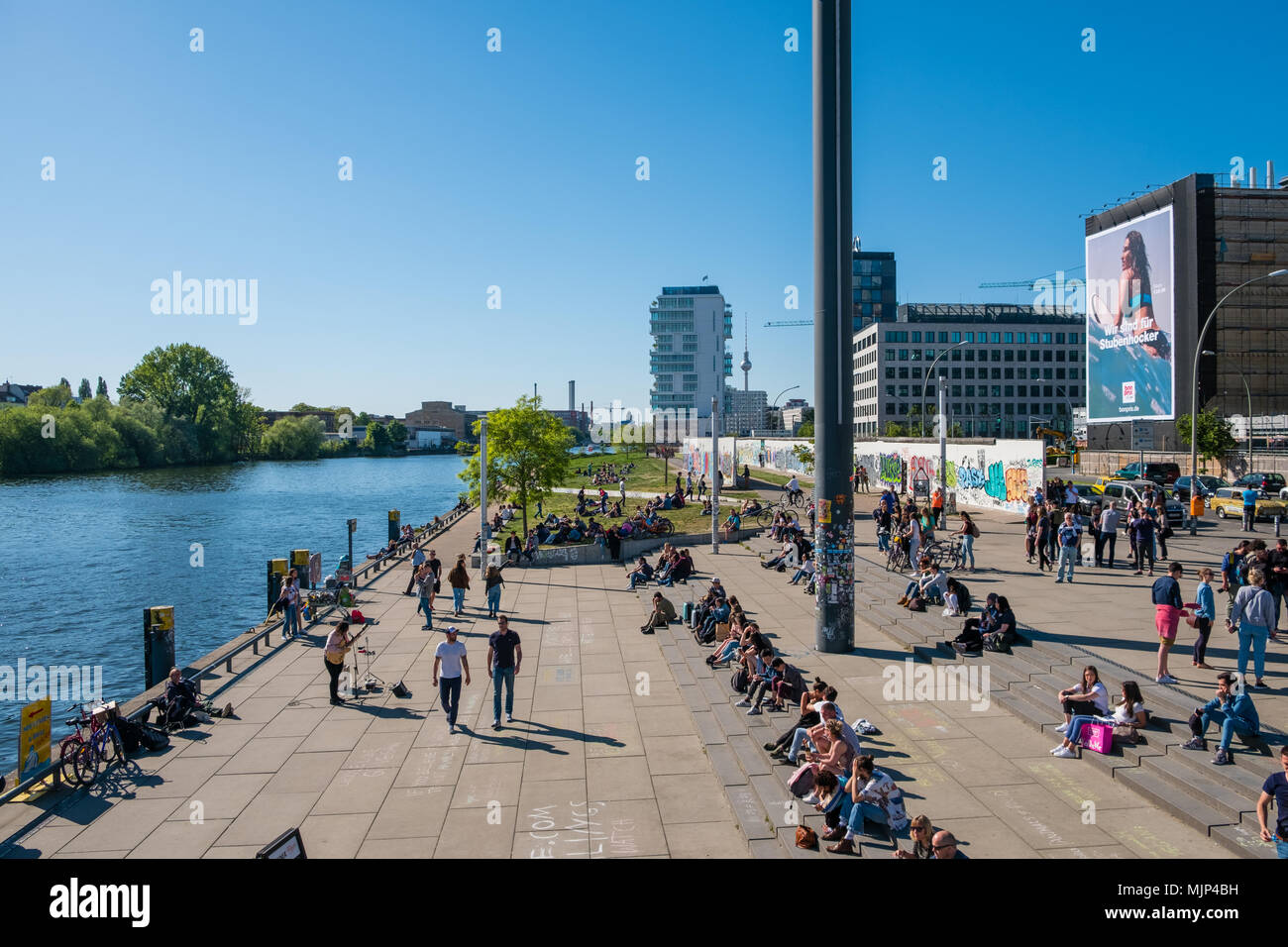 Berlin, Deutschland - Mai, 2018: Viele Leute an der Spree an der Berliner Mauer (East Side Gallery) an einem sonnigen Tag in Berlin, Deutschland Stockfoto