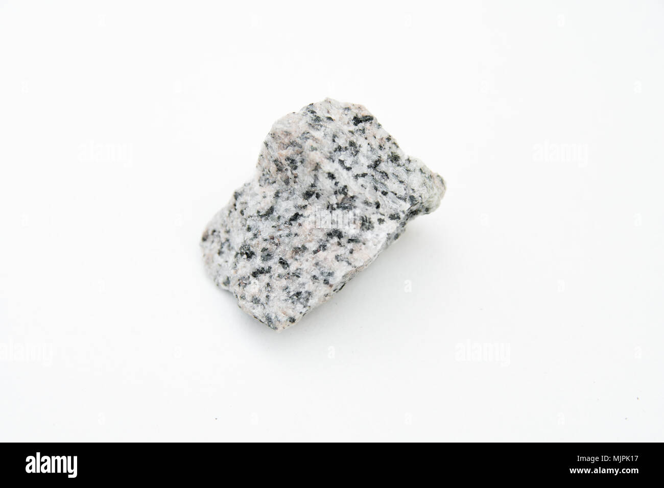 Extreme close up mit einer Menge von Details der granodiorit Rock auf weißem Hintergrund Stockfoto