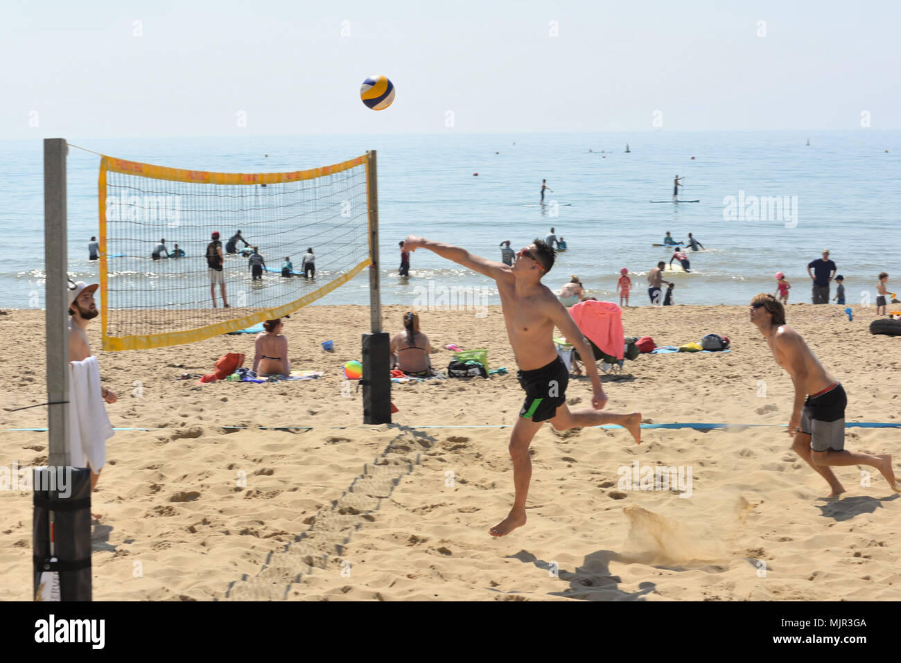 Boscombe, Bournemouth, Dorset, UK, 6. Mai 2018, Wetter: Morgen Sonnenschein an der Südküste auf, was die heißesten Mayday Bank Holiday Wochenende festgehalten werden könnte. Junge Männer spielen Beachvolleyball in der perfekte Bedingungen. Stockfoto