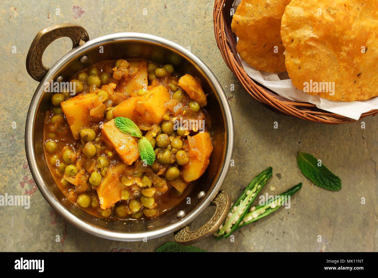 Alu Matar (Aloo Mutter) serviert mit Masala Puri oder Poori/Indische Kartoffeln Pes curry Stockfoto