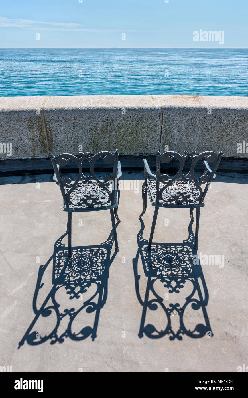 Zwei Stühle, blaues Meer, Sonnenschein, Silhouette, den Hafen von Folkestone Arm, Folkestone, Kent, England, Großbritannien Stockfoto