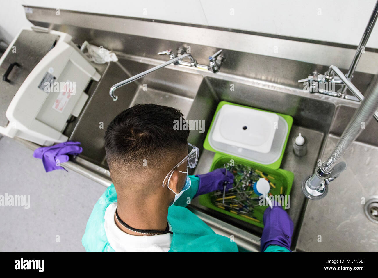 Pfc. Claude Daniel, eine Armee finden Zahntechniker, Scrubs zahnmedizinische Instrumente vor der Sterilisation in der Betreuung Hafen, in Los Angeles, Calif., Nov. 18, 2017. Daniel ist eines von Dutzenden von Soldaten aus der 7214Th Medical Support Unit, in Los Alamitos, Calif., die freiwillig helfen medizinische Dienstleistungen für die Bürger von Los Angeles bieten stationiert, von denen viele nicht die medizinische Versorgung erhalten haben. (U.S. Armee Foto: Staff Sgt. Felix R. Fimbres) Stockfoto