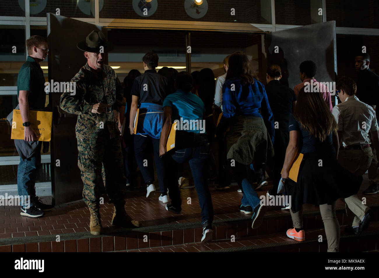 Senior drill instructor Staff Sgt. Michael bedeutet Jr. Gibt die jungen Männer und Frauen, die nur auf die gelben Spuren den ersten Bestellungen auf Parris Island trat. Diese jungen Männer und Frauen werden festgelegt, Delta und Oscar Unternehmen ihre Ausbildung in den nächsten Tagen zu beginnen. (Foto von Lance Cpl. Carlin Warren) Stockfoto