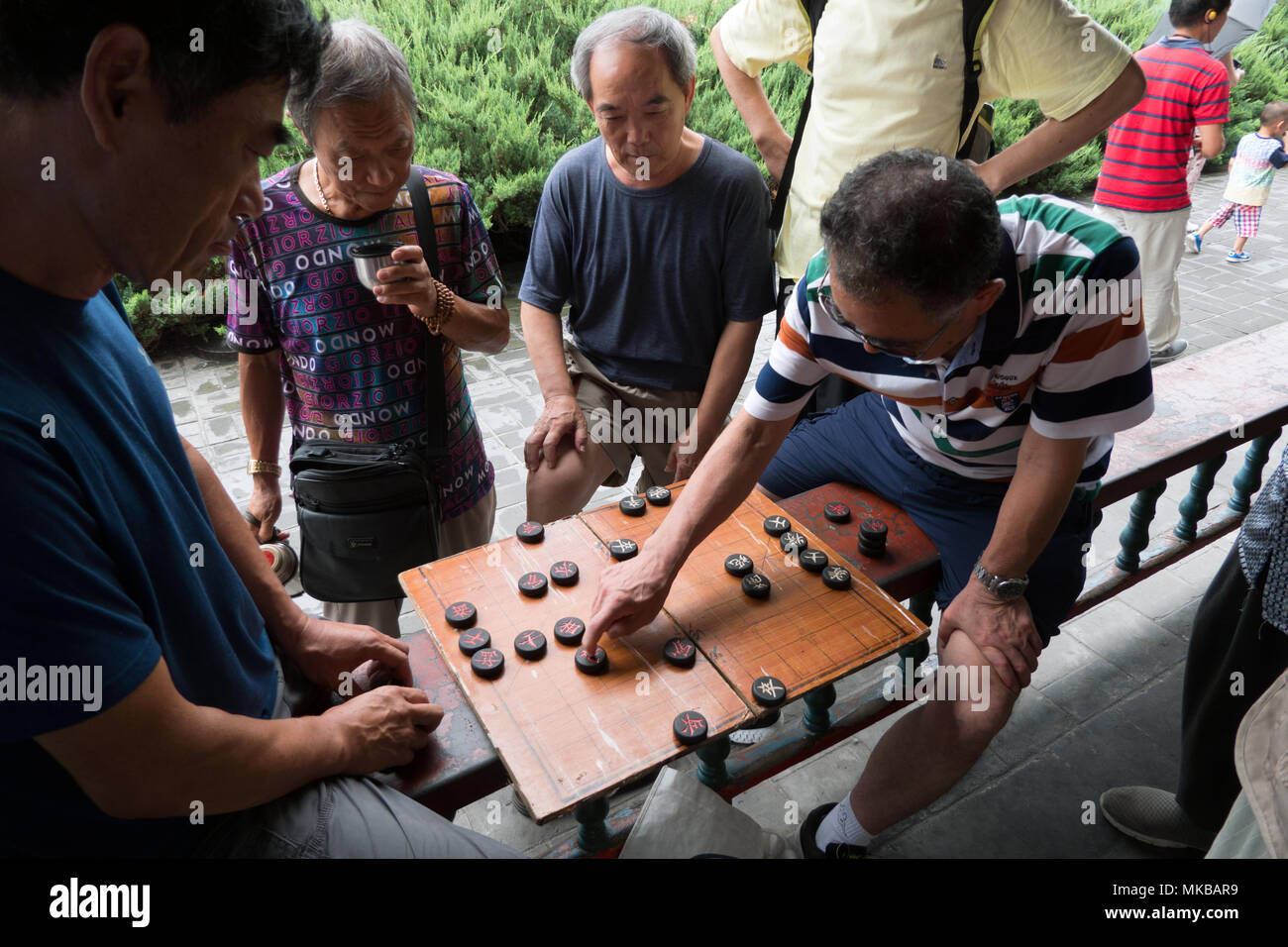 Chinesische Männer spielen traditionelle checkers Spiel in Peking, China, Asien. Freunde Spaß mit Freizeitaktivitäten Aktivität Stockfoto