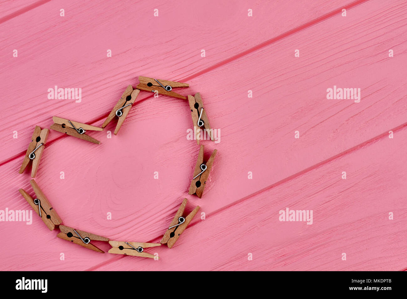 Draufsicht auf das Herz aus Vintage Wäscheklammern. Valentine Herz aus Holz  Wäscheklammern auf rosa Hintergrund mit kopieren Stockfotografie - Alamy