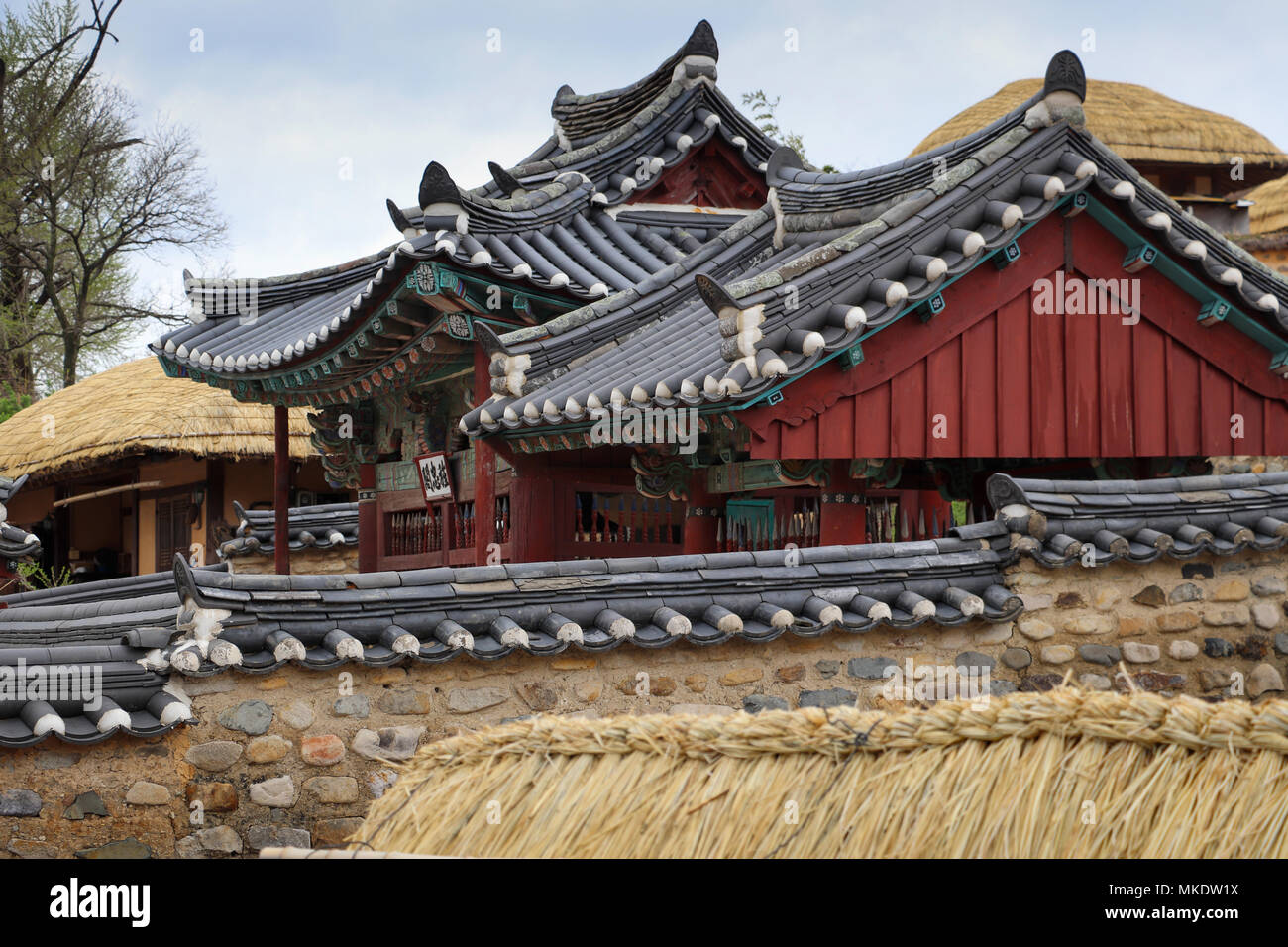 Ein gefliestes Dach Pavillon auf der Yangdong Folk Village in der Nähe von Gyeongju, Südkorea, hat ein dichtes Dach, Steinmauer Gehäuse; in der Nähe Häuser sind reetgedeckte Stockfoto
