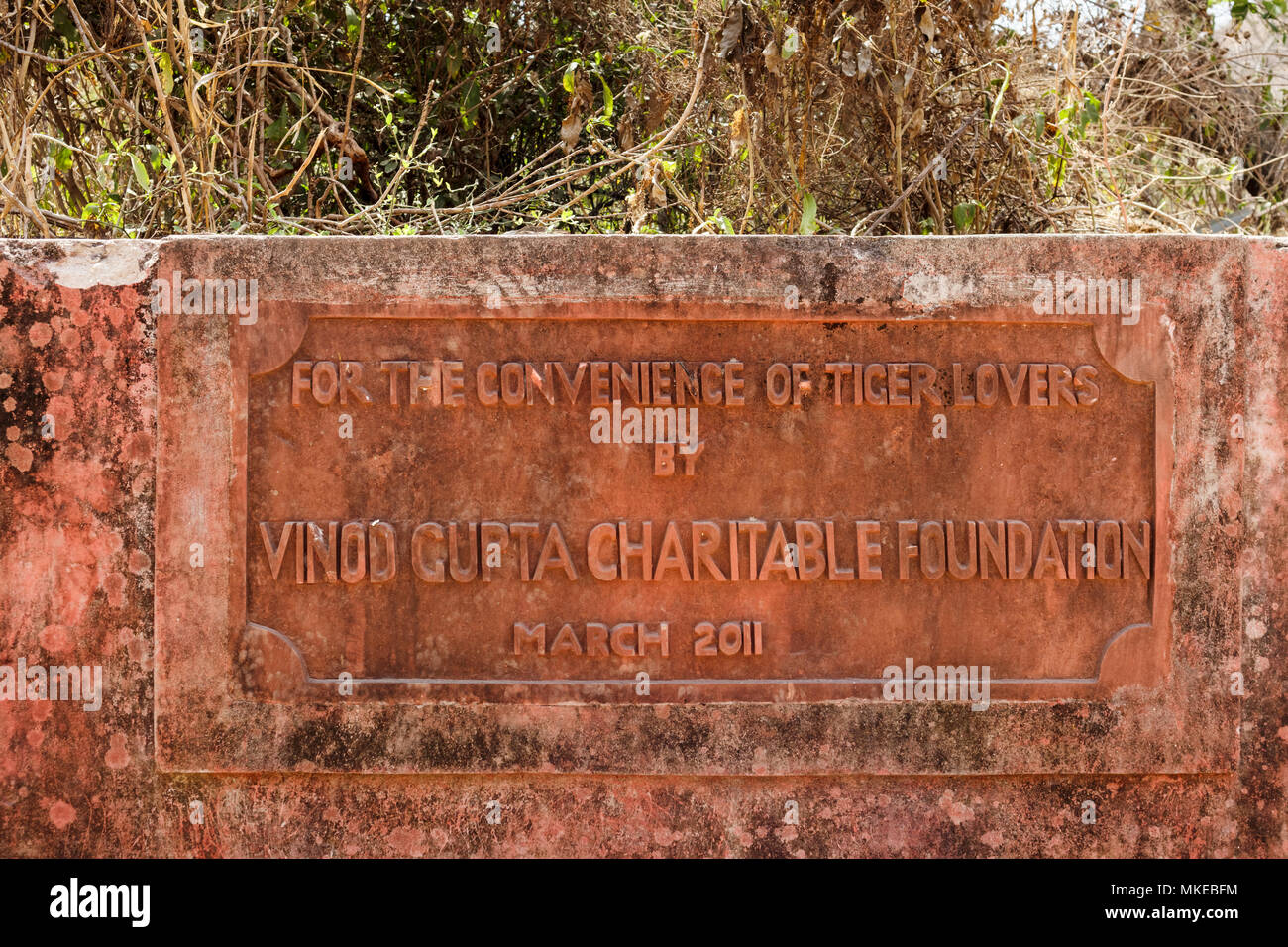 Stein Zeichen beschriftet mit 'Für die Bequemlichkeit der Tiger Liebhaber von Vinod Gupta Gemeinnützige Stiftung", Ranthambore Nationalpark, Rajasthan, Indien Stockfoto