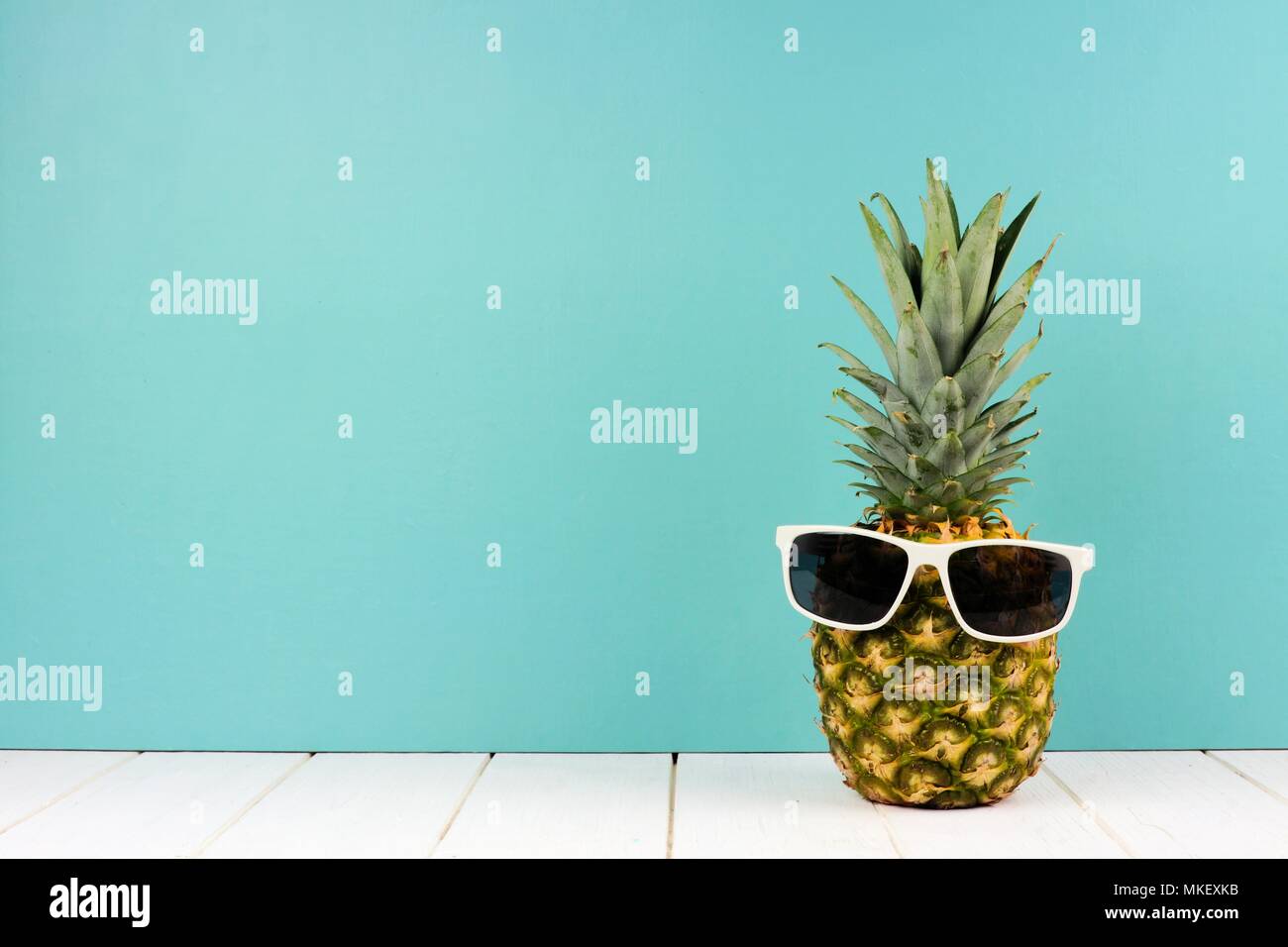 Hipster Ananas mit trendigen Sonnenbrillen gegen türkis Hintergrund. Minimale Sommer Konzept. Stockfoto