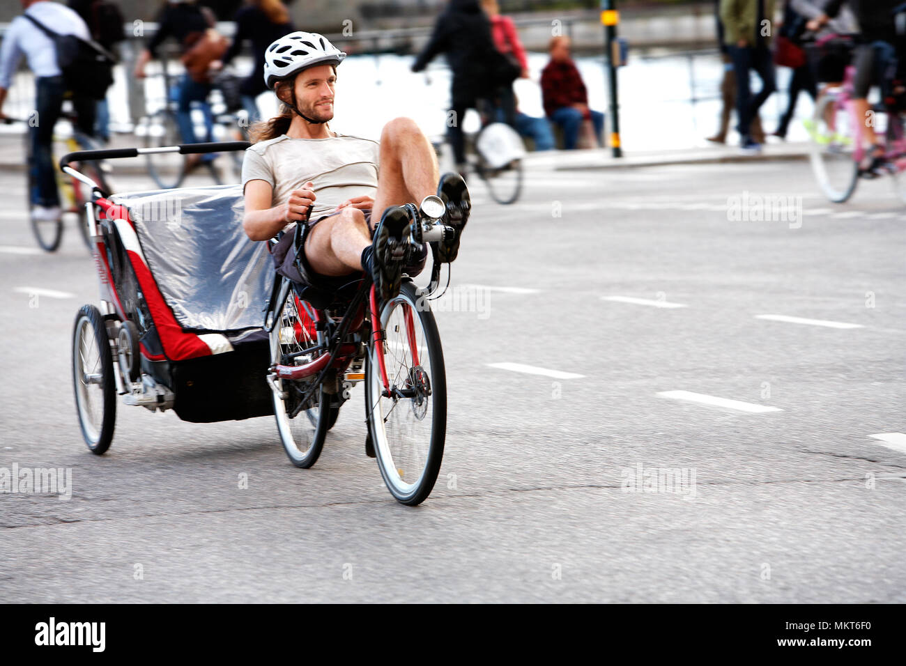 Eine Person Fahrrad liegend auf seinem liegerad mit Anhänger in Stockholm, Schweden. Stockfoto