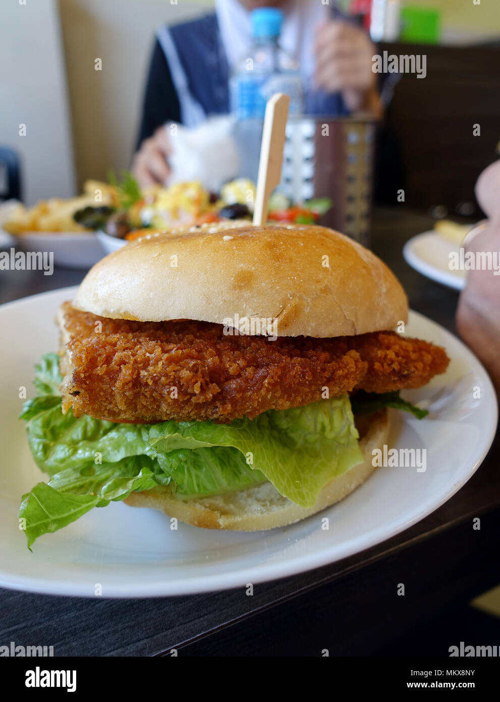 Hähnchen schnitzel Burger auf einem weißen Teller Stockfoto