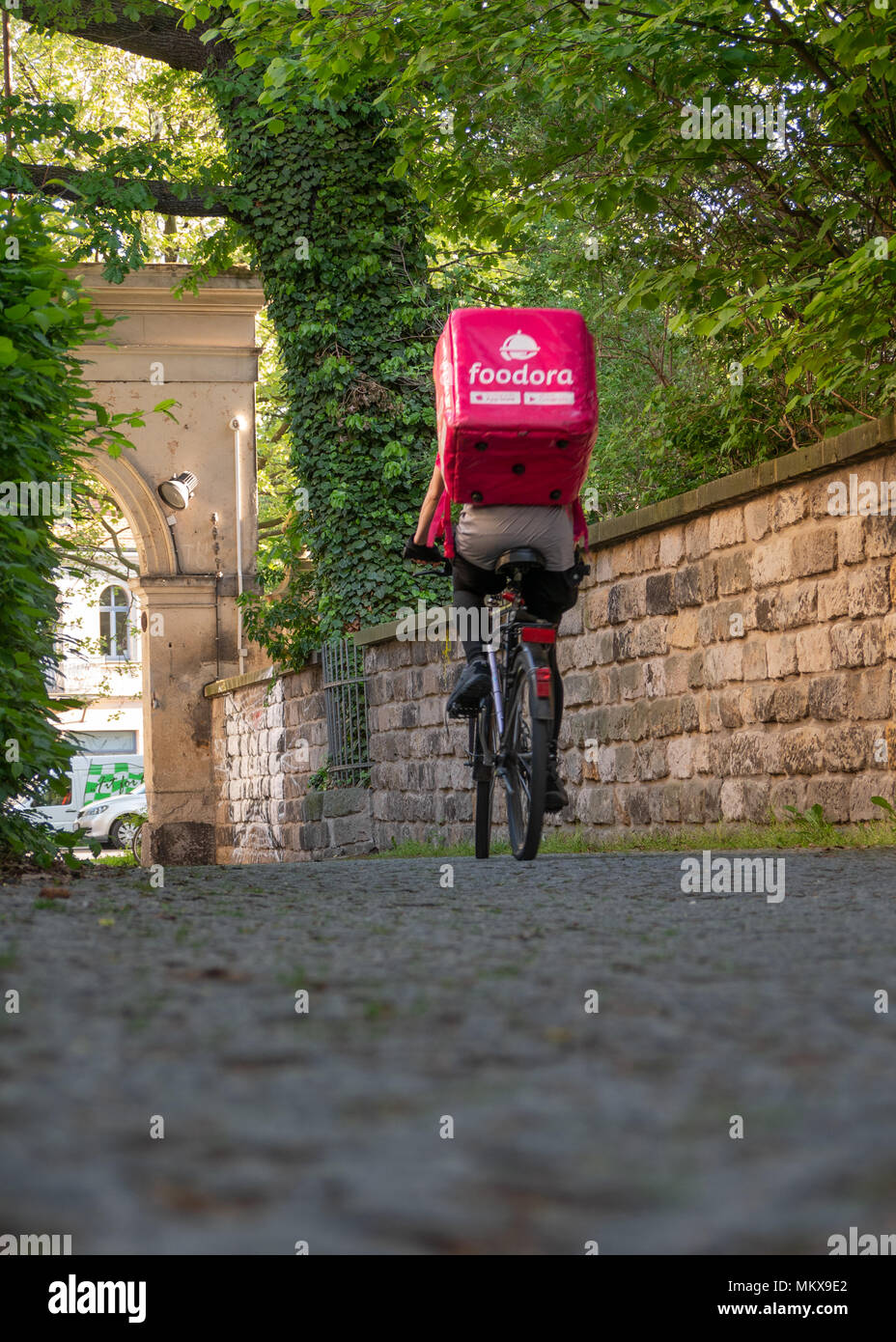 Dresden, Deutschland: Essen Lieferservice. Eine weibliche foodora Kurier auf dem Weg zum nächsten Restaurant. Stockfoto