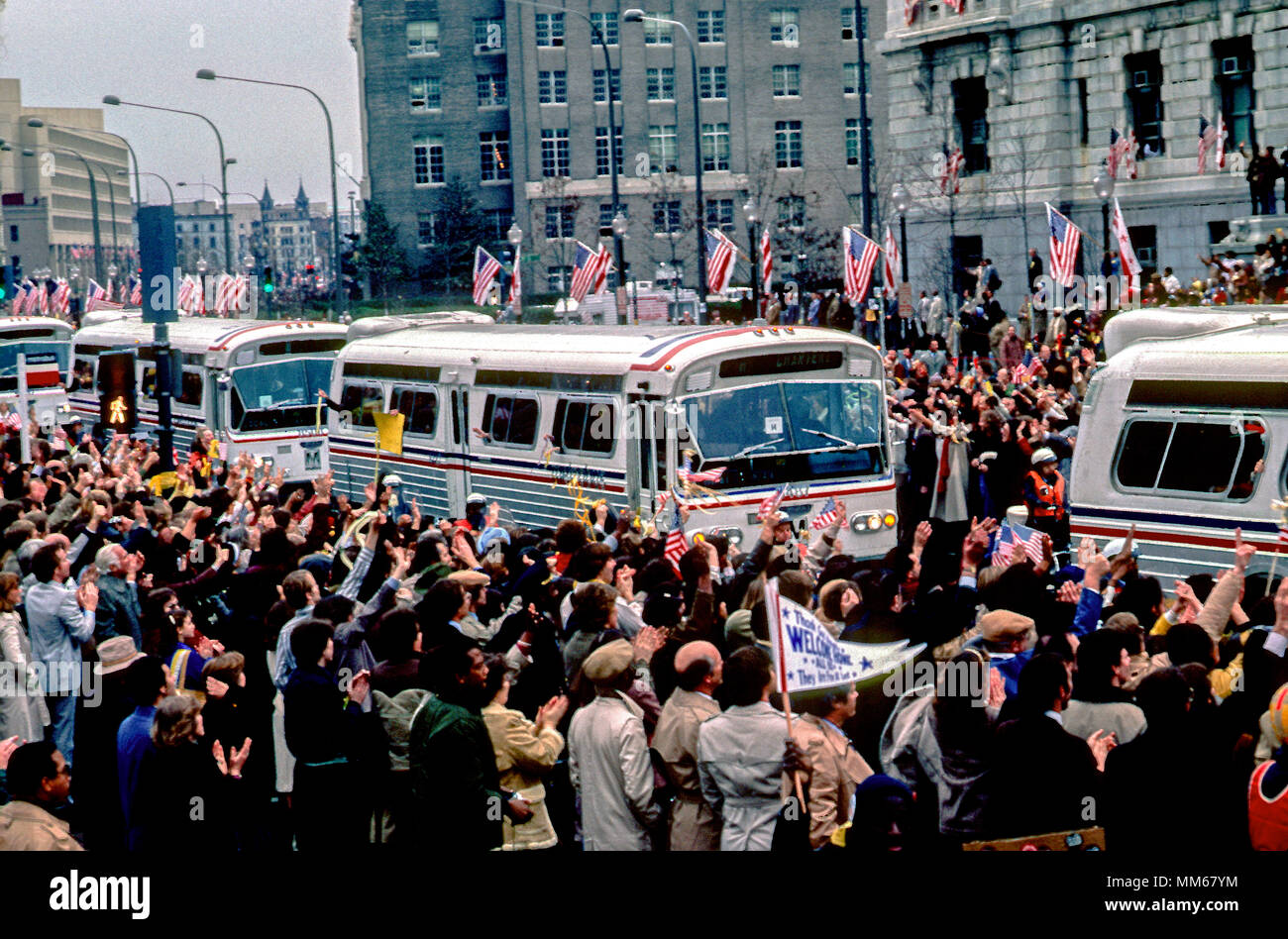 Washington DC, USA, 27. Januar 1981 Die Busse der 52 Amerikaner, die Geisel von den Iranern für 444 Tage gehalten wurden, sind durch eine massive Menge winkend Symbolische gelben Bänder entlang der Pennsylvania Avenue bei Freedom Plaza begrüßt Stockfoto