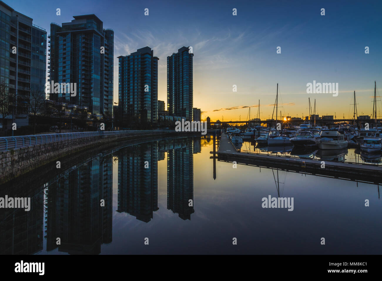 Schöne Stadtbild von Kai Marina bei Sonnenaufgang mit Reflexionen von Gebäuden und Boote im ruhigen Wasser, Vancouver, British Columbia genommen Stockfoto