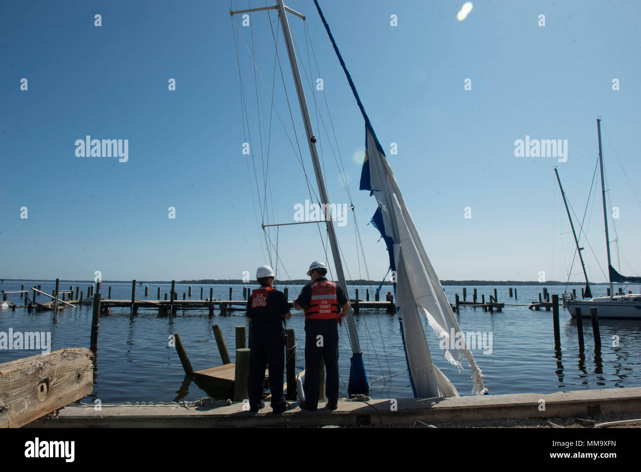 Coast Guard Marine Science Techniker Petty Officer 1st Class Tonya Mulhern, Links, und Petty Officer 3rd Class Stephen Hewlett beurteilen Schäden auf ein Schiff in Jacksonville, Florida durch Hurrikan Irma, Sept. 13, 2017. Hunderte von Schiffen wurden berichtet als beschädigt oder haben um das Floridian Küsten als Folge des Hurrikans Irmas force versenkt. Teams bestehend aus Bund und Laendern Antwort Mitglieder sind die Bewertung der potenziellen Risiken der Umweltverschmutzung durch die Schiffe. U.S. Coast Guard Foto von Petty Officer 2. Klasse Anthony L. Soto Stockfoto