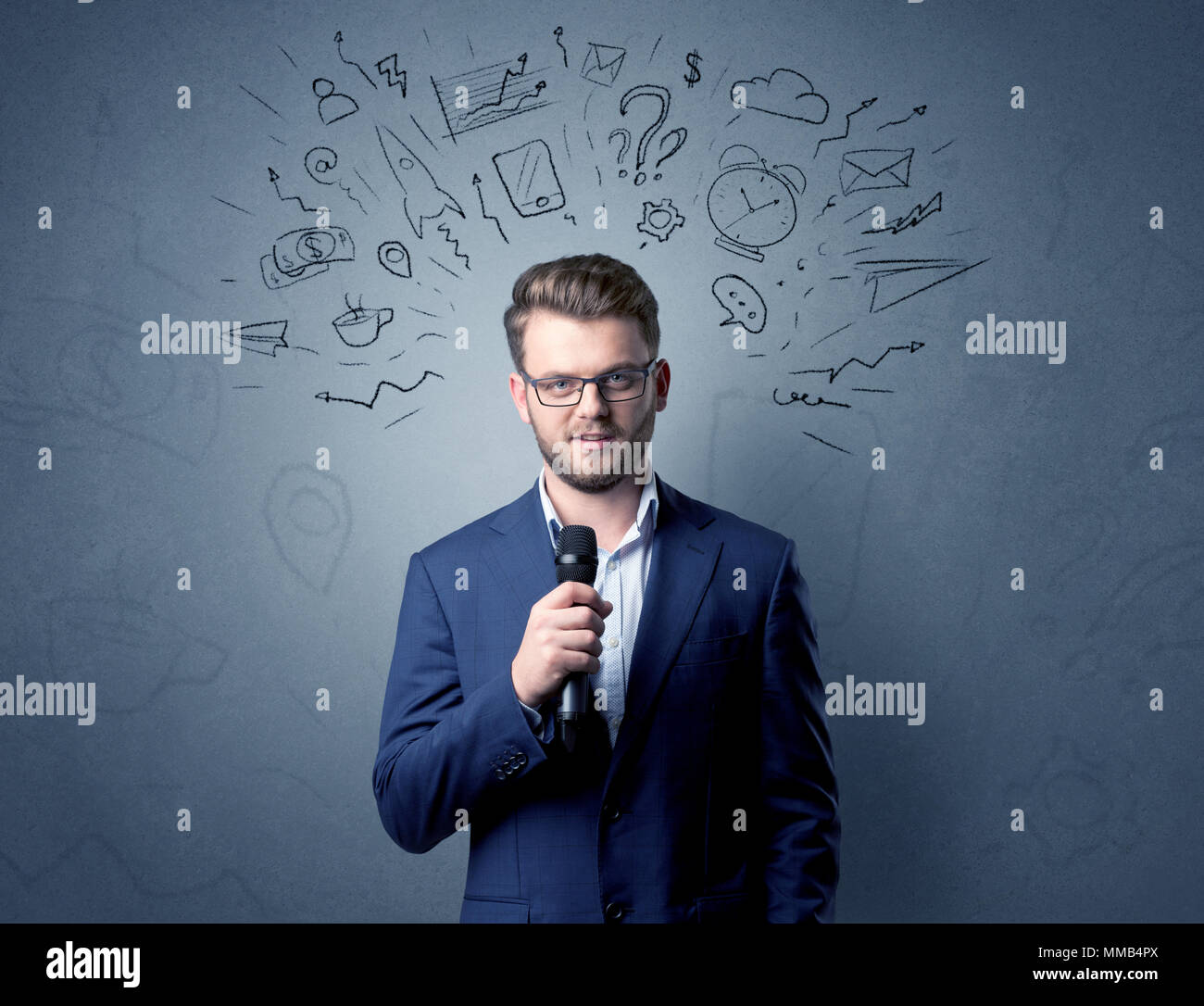 Geschäftsmann sprechen in das Mikrofon mit gemischten Doodles über seinem Kopf Stockfoto