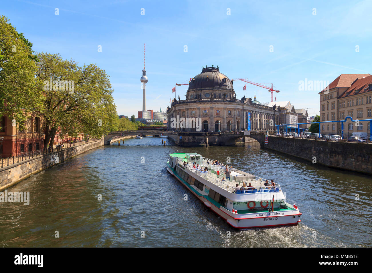 Die Leute, die die Stadt Berlin mit einer touristischen Schiff, im Museum Insel mit Fernsehturm im Hintergrund Stockfoto