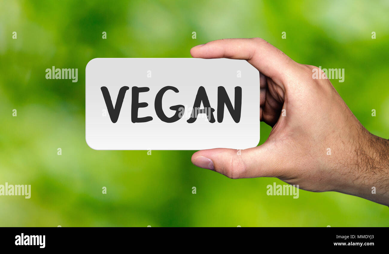 Hand, die Plakette mit Wort "GAN". VEGAN Konzept. Vector lieferbar. Stockfoto