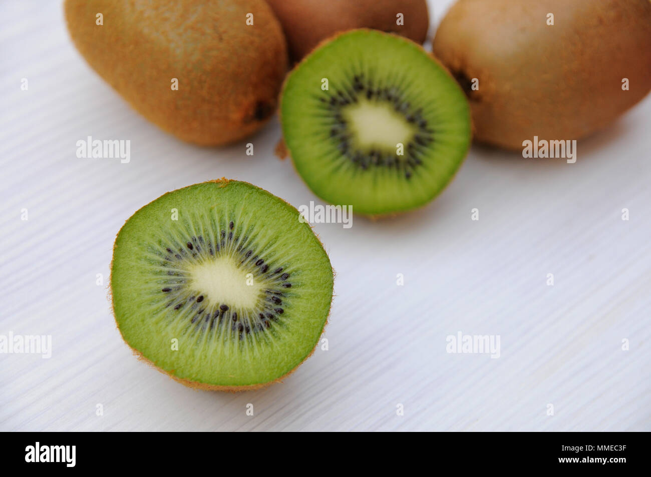 Kiwi in Scheiben geschnitten auf dem hölzernen Tisch Stockfoto
