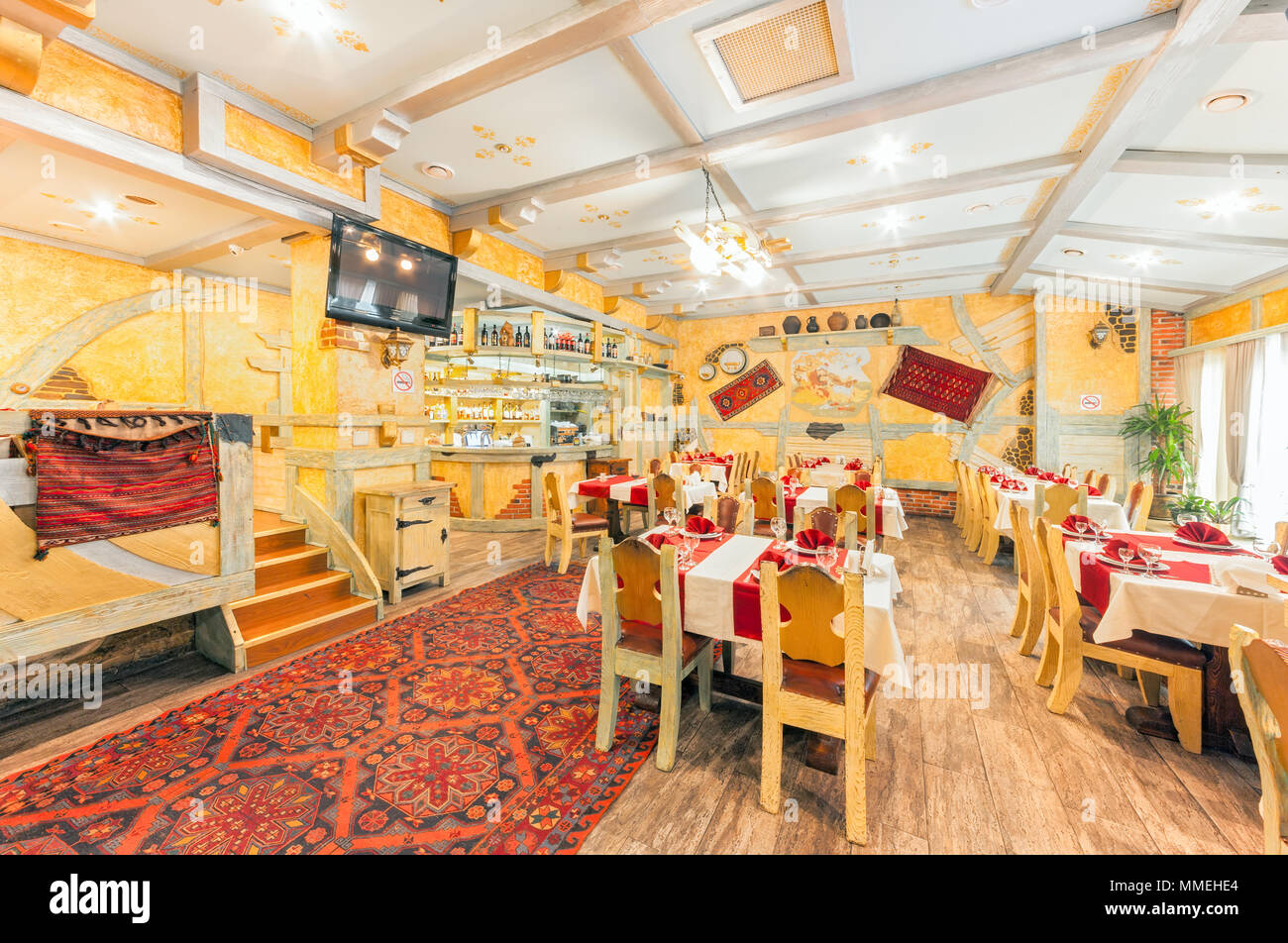 Moskau - AUGUST 2014: das Interieur des Restaurants "RIO GRANDE". Halle der gelbe Farbe, in der ein Bauer Stil dekoriert mit Holzmöbeln Stockfoto