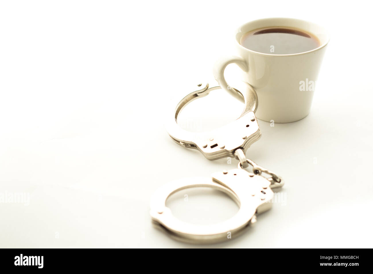 Handschellen mit Kaffee Stockfoto