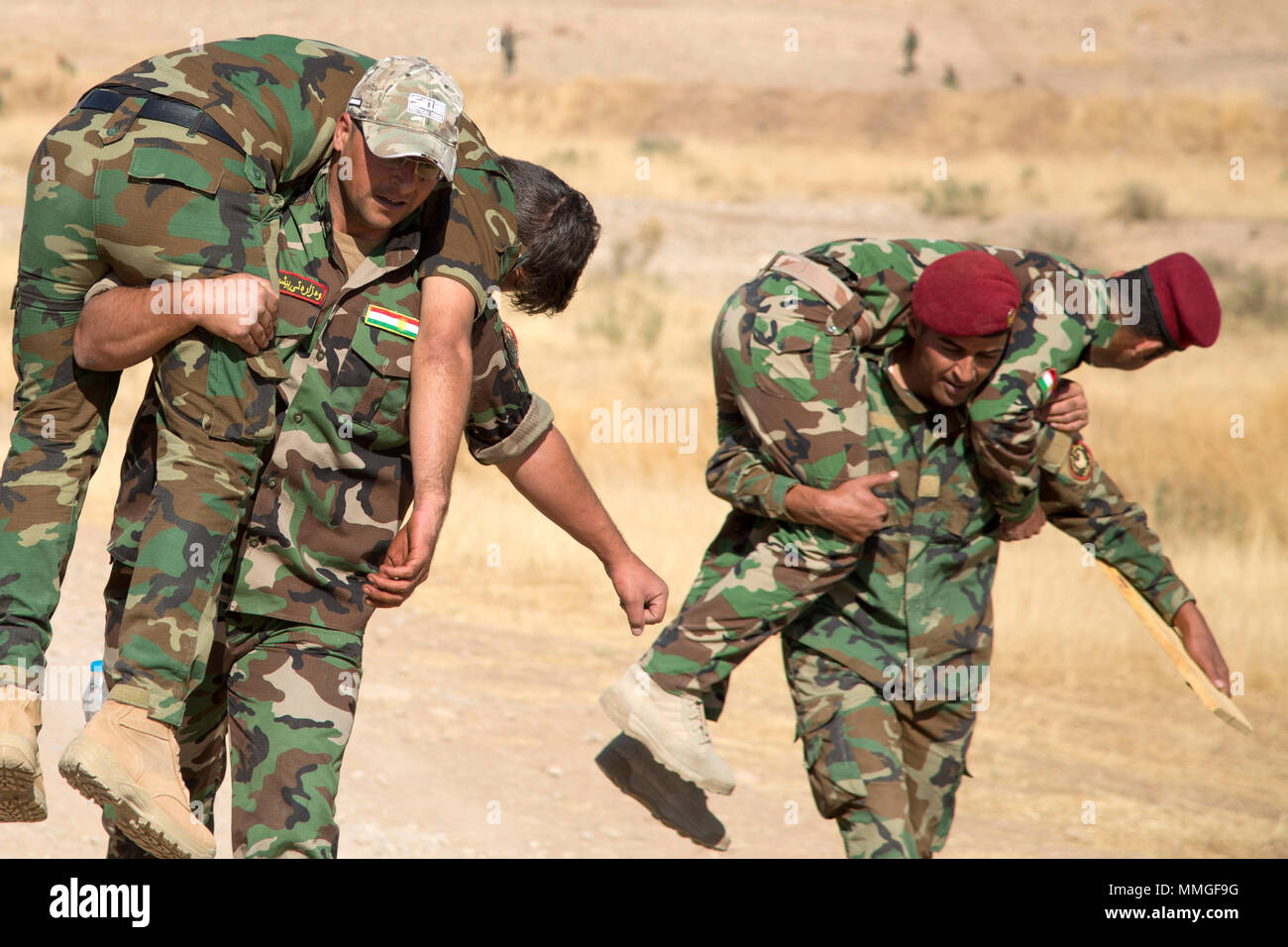 Peshmerga Soldaten tragen simulierten Verluste während Tactical combat Casualty care Ausbildung an der Kurdistan Zentrum für die Koordinierung der Ausbildung in der Nähe von Erbil, Irak, 12. Oktober 2017. Die KTCC ist ein Combined Joint Task Force - inhärenten Building Partner Kapazität beheben Standort Training Partner Kräfte und Verstärkung ihrer Wirksamkeit auf dem Schlachtfeld gewidmet. CJTF-OIR ist die globale Koalition zu besiegen ISIS im Irak und in Syrien. (U.S. Armee Foto von Sgt. Tracy McKithern) Stockfoto