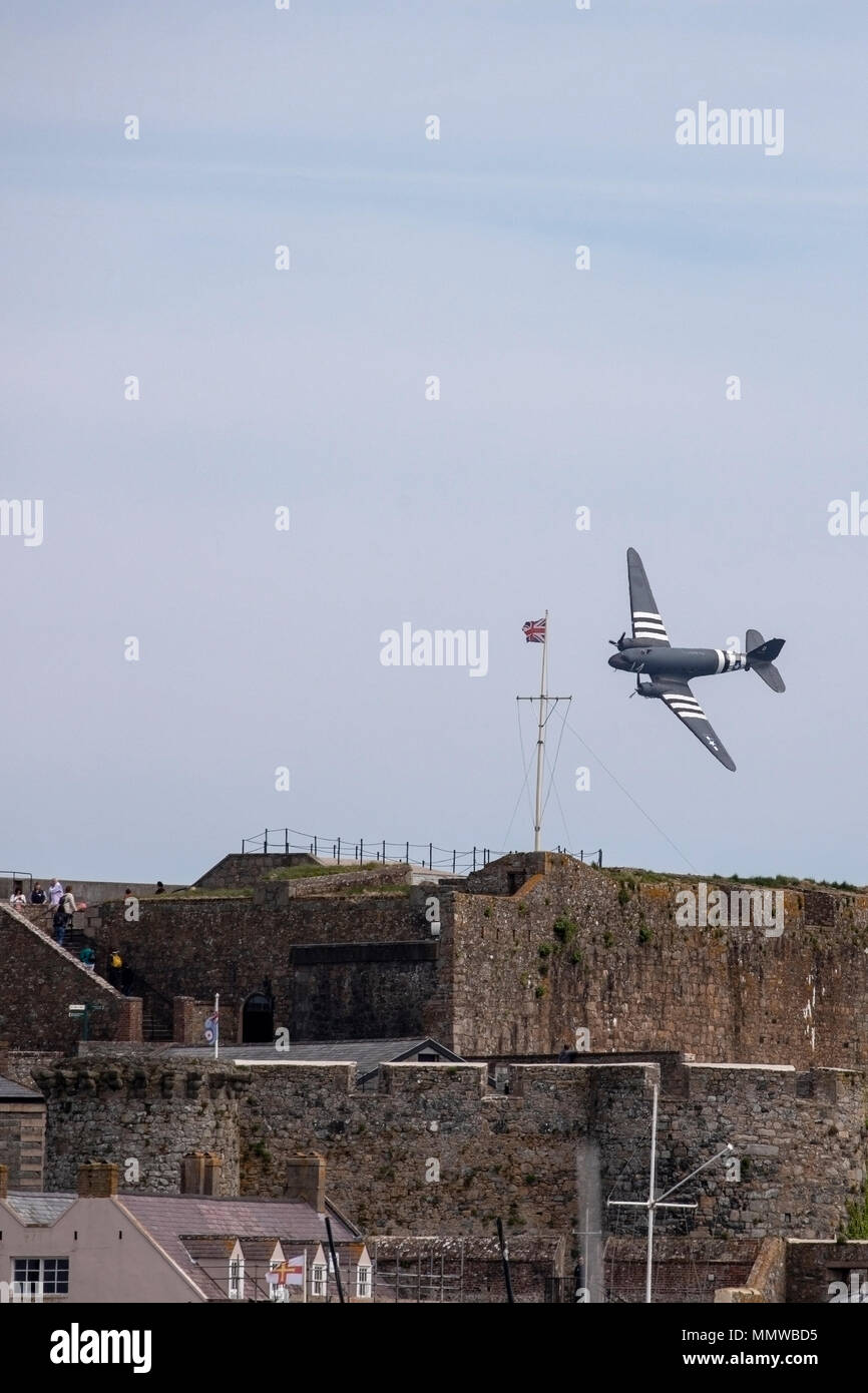 Die tatsächliche Douglas C-47 Skytrain als Dakota im Guernsey Literary and Potato Peel Pie Society Film fliegt über Castle Cornet am Jahrestag der Befreiung Stockfoto