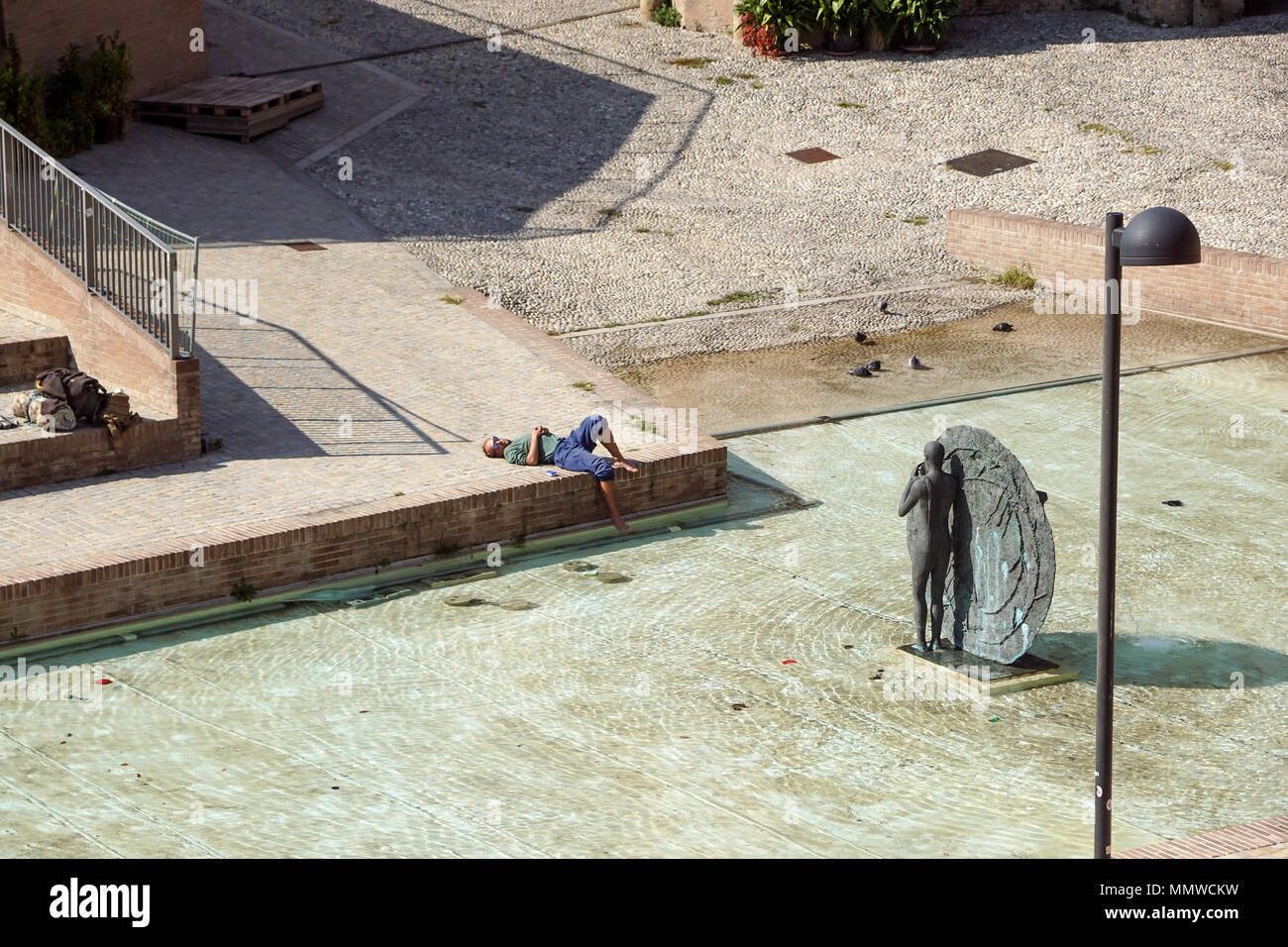 Bologna, Italien - 15 April 2018:. Ein unbekannter Mann entspannt unter der Sonne in der modernen Stadt Platz. Am Nachmittag in der Innenstadt entspannen Stockfoto