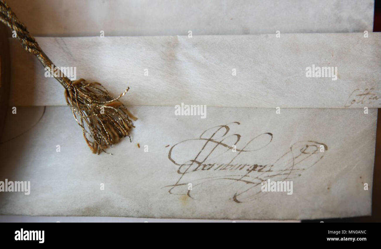 . English: Kaiserlichen Unterschrift vom Adelsdiplom von Rudolf II. (Römisch-deutscher Kaiser 1576-1612) für den Gelehrten und Höfling Flaminius Garnier († 10. Juni 1592), Sekretär des Herzogs von Parma sowie Diplomat in Diensten der Kaiser Maximilian II. und Rudolf II. Garnier ist in der Kirche Notre Dame du Sablon in Brüssel begraben. Adelsdiplom ausgestellt Wien, 26. Mai 1578, mit eigenhändiger Unterschrift des Kaisers. Pergamenturkunde (Format 57 x 80 cm), von Hand kalligraphiert, mit farbiger Wappendarstellung. Mittels Kordel anhängendes kaiserliches Wachssiegel in hölzerner Siegelkapsel ( Stockfoto