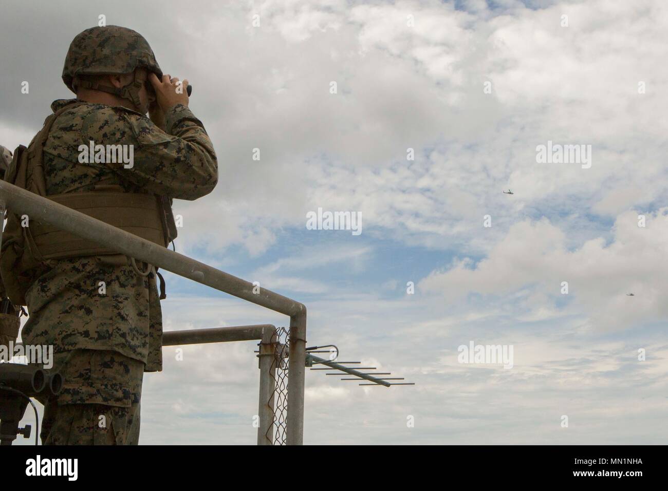 Ein Marine mit 2. Air Naval Geschützfeuer Liaison Unternehmen nutzt das Fernglas für einen entfernten fiktiven Ziel beim Close Air Support Training bei BT11, Atlantic Flugplatz, N.C., Aug 3, 2017 zu suchen. Close Air Support ist Luft durch Flugzeuge gegen feindliche Ziele, die in der Nähe von Friendly Kräfte sind. (U.S. Marine Corps Foto von Lance Cpl. Abrey D. Liggins) Stockfoto