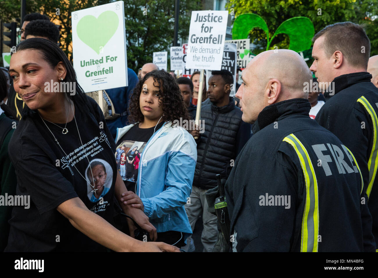 London, Großbritannien. 14 Mai, 2018. Mitglieder der Grenfell Gemeinschaft zeigen ihre Anerkennung für die Londoner Feuerwehr Feuerwehrmänner bilden ein Spalier für die Grenfell Schweigemarsch. Der März, die auf der monatlichen Jahrestag der Feuer braucht, um am 14. Juni 2017, wurde jetzt auf der ursprünglichen Route ab dem Notting Hill methodistische Kirche zurückgekehrt. 71 Menschen in der Grenfell Turm Feuer und über 70 Tote wurden verletzt. Credit: Mark Kerrison/Alamy leben Nachrichten Stockfoto