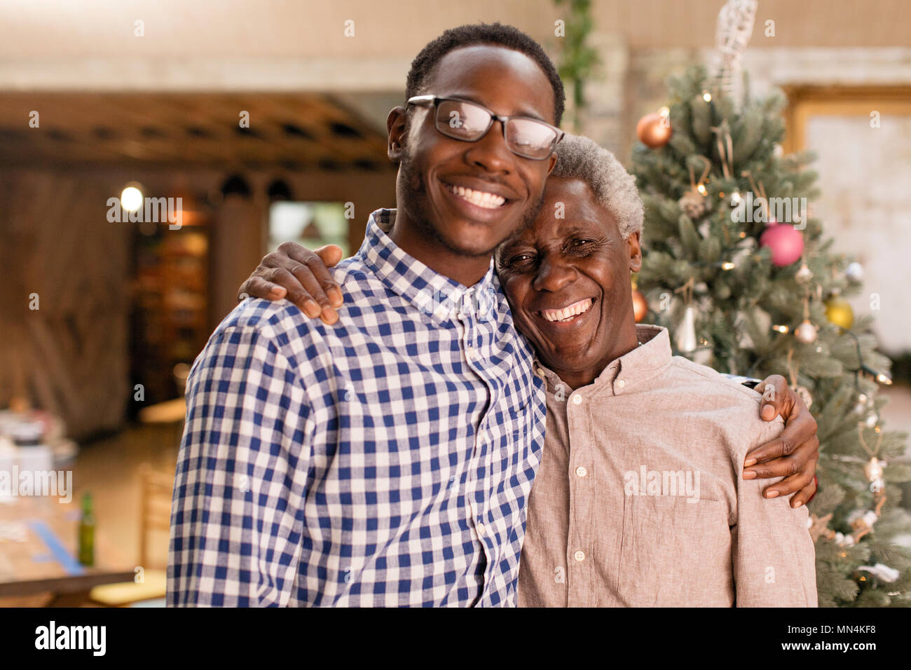 Portrait lächelnden Großvater und Enkel umarmen vor Weihnachtsbaum Stockfoto