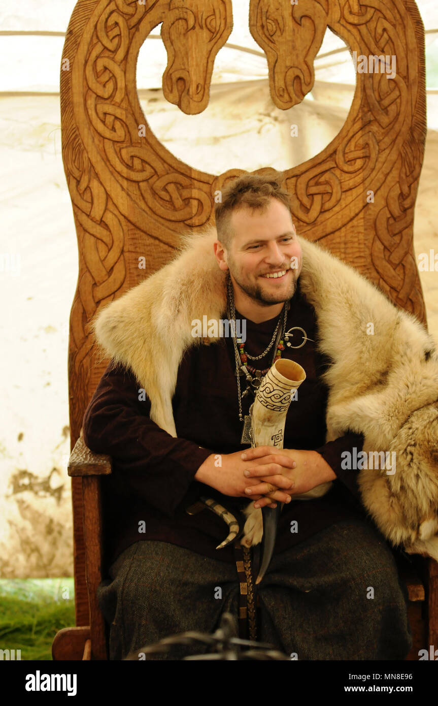 Viking saß in reich verzierten hölzernen Stuhl tragen tierischer Haut Stockfoto