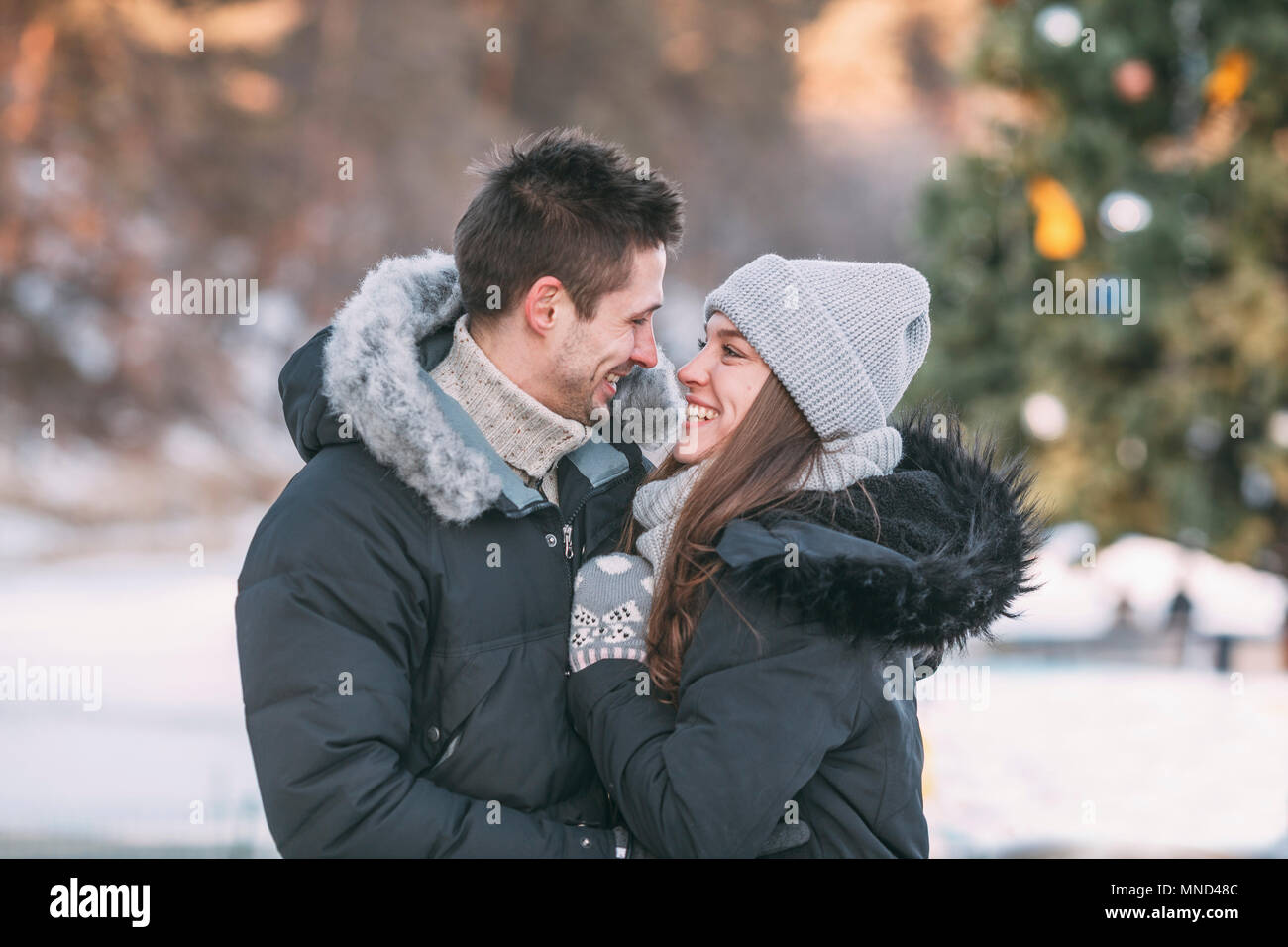 Lächelndes Paar warme Kleidung tragen, stehen im Freien Stockfoto