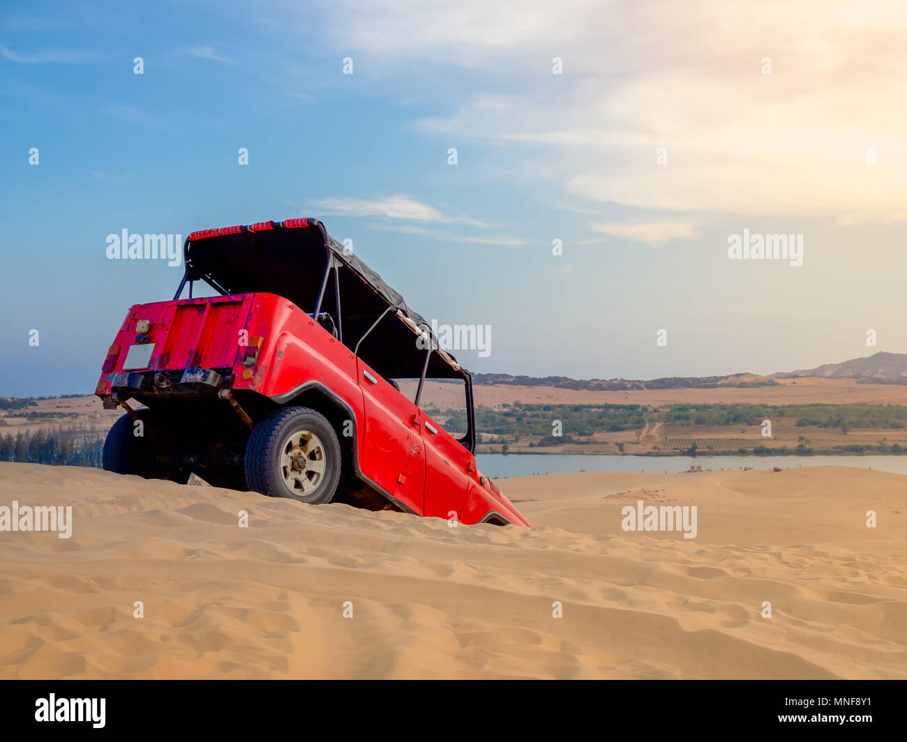 Red Off Road Auto Fahrzeug für Abenteuer Rubrik auf die Sanddünen in Mui Ne, Vietnam auf dem Sunset Landschaft Stockfoto